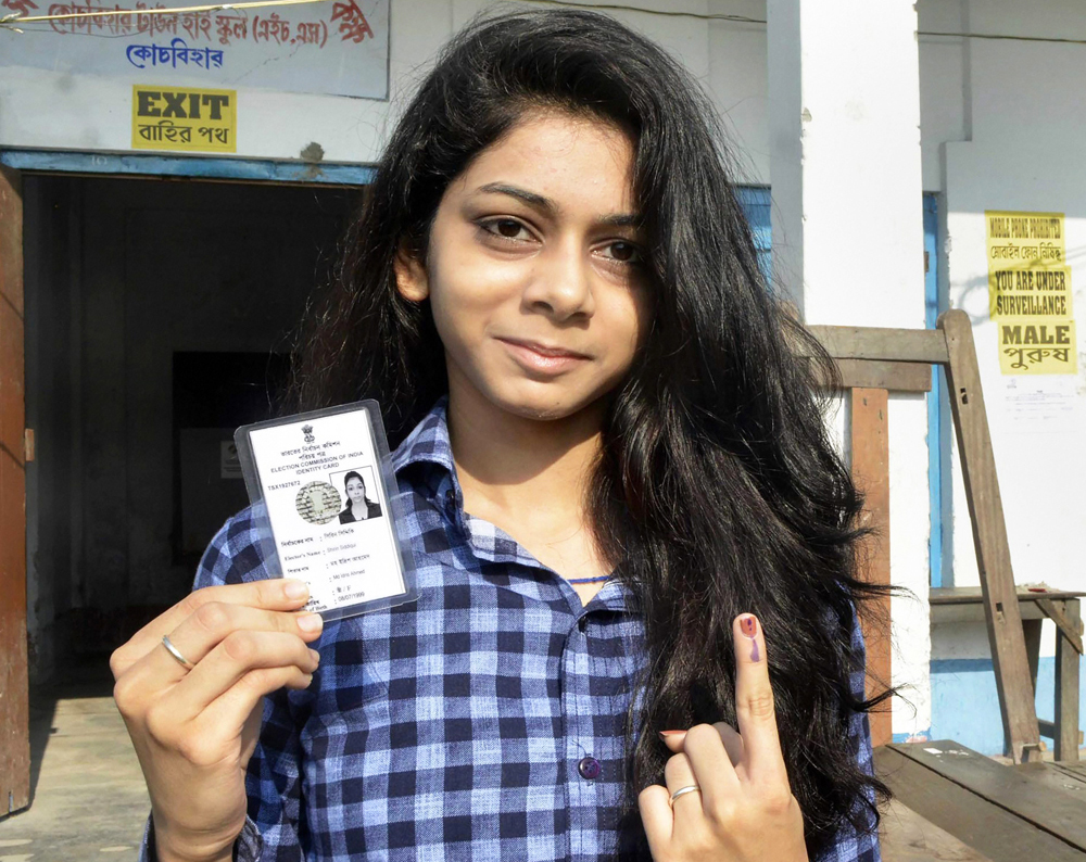 A young voter shows her finger marked with indelible ink after casting vote during the first phase of the general elections at a polling station in Cooch Behar district of West Bengal on Thursday, April 11, 2019. 