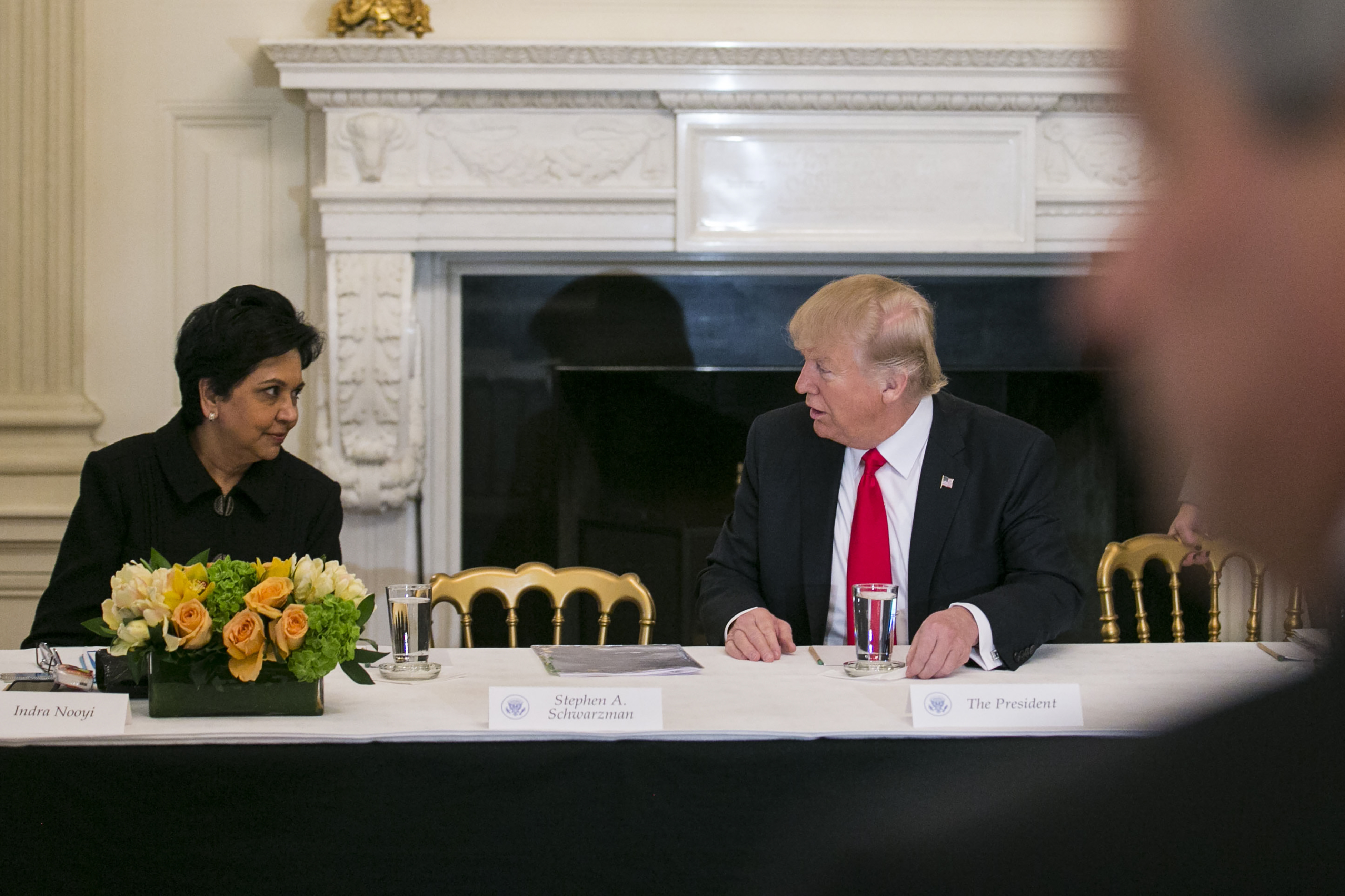 A file photo shows Indra Nooyi speaking to Donald Trump at the White House.