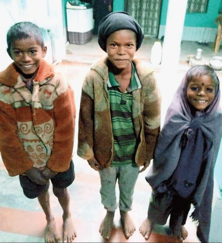 The children in the woollen clothes given by the NGO. 

