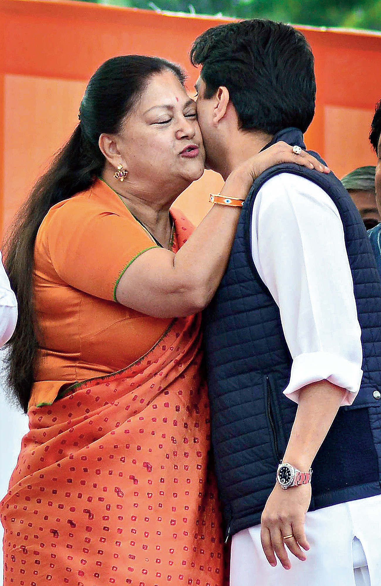 BJP leader Raje greets Congress leader and her nephew Scindia in Jaipur on Monday.