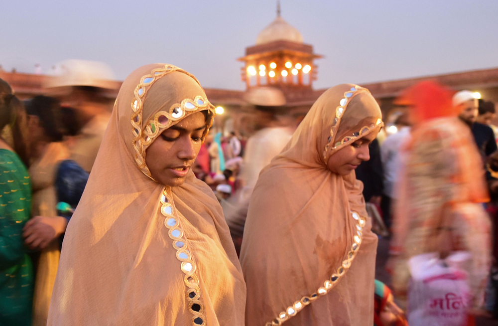 Women offer prayers at the Jama Masjid to break their day-long fast during Iftar on the last Friday of the holy month of Ramadan in old Delhi, Friday, May 31, 2019.