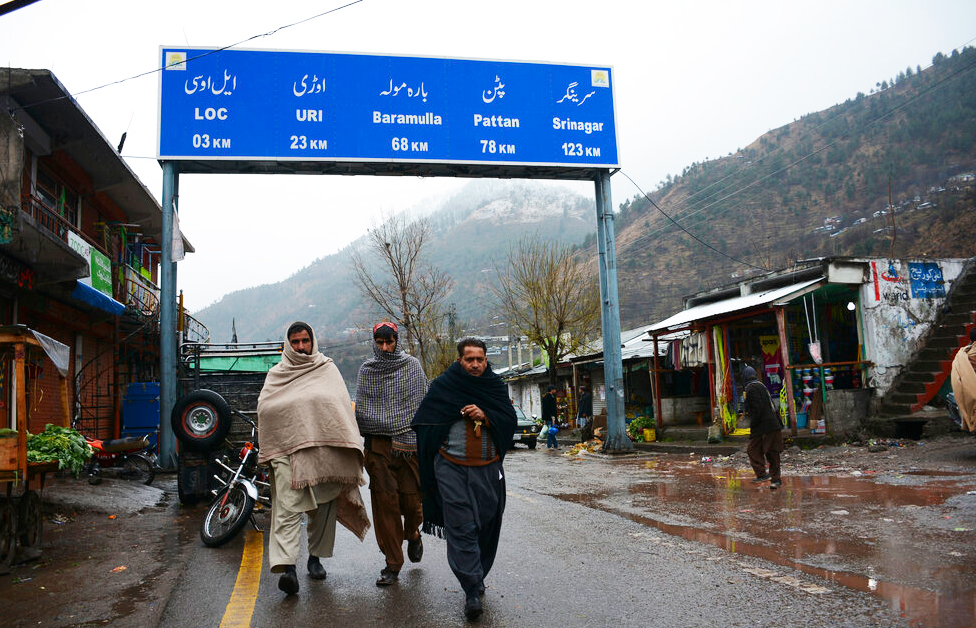 Kashmiris walk through the border town of Chakoti at the Line of Control in Pakistan occupied Kashmir on Tuesday, Feb. 26, 2019.