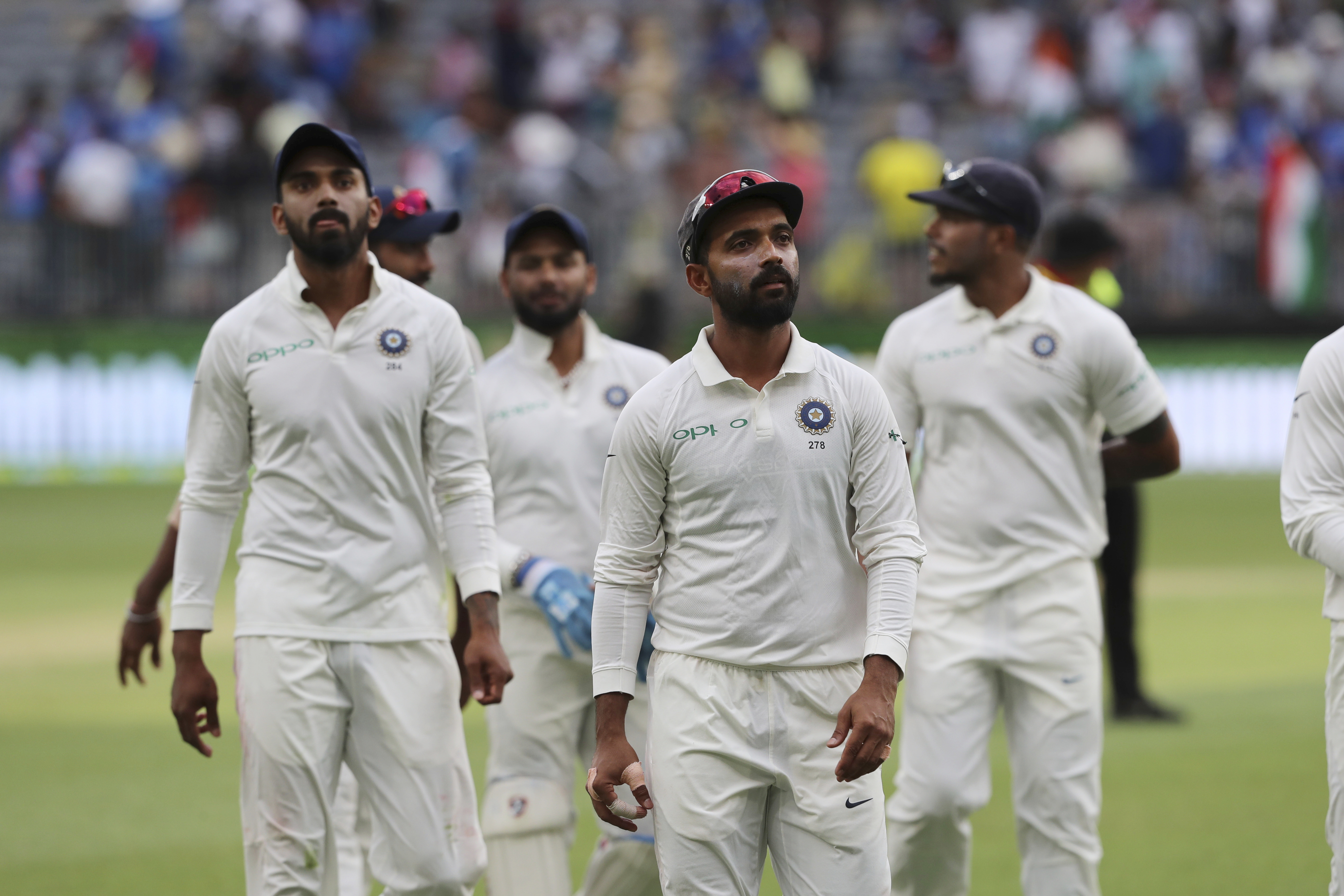 India's Ajinkya Rahane (second from right) leads his teammates off the ground at the conclusion of the third day's play in the second cricket Test between Australia and India in Perth on Sunday.