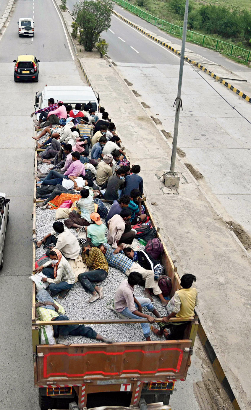 Migrants from Mumbai travel on a truck to their home states.