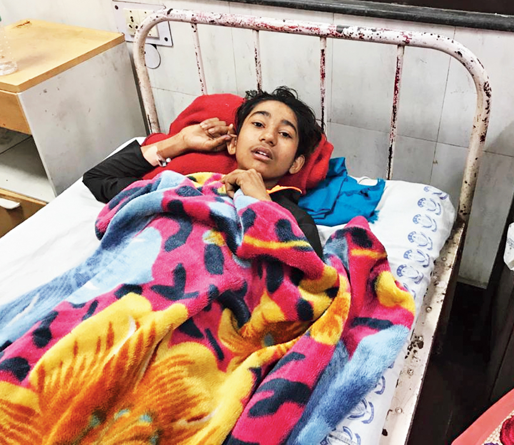 Faizan in his hospital bed, recovering from a gunshot wound 