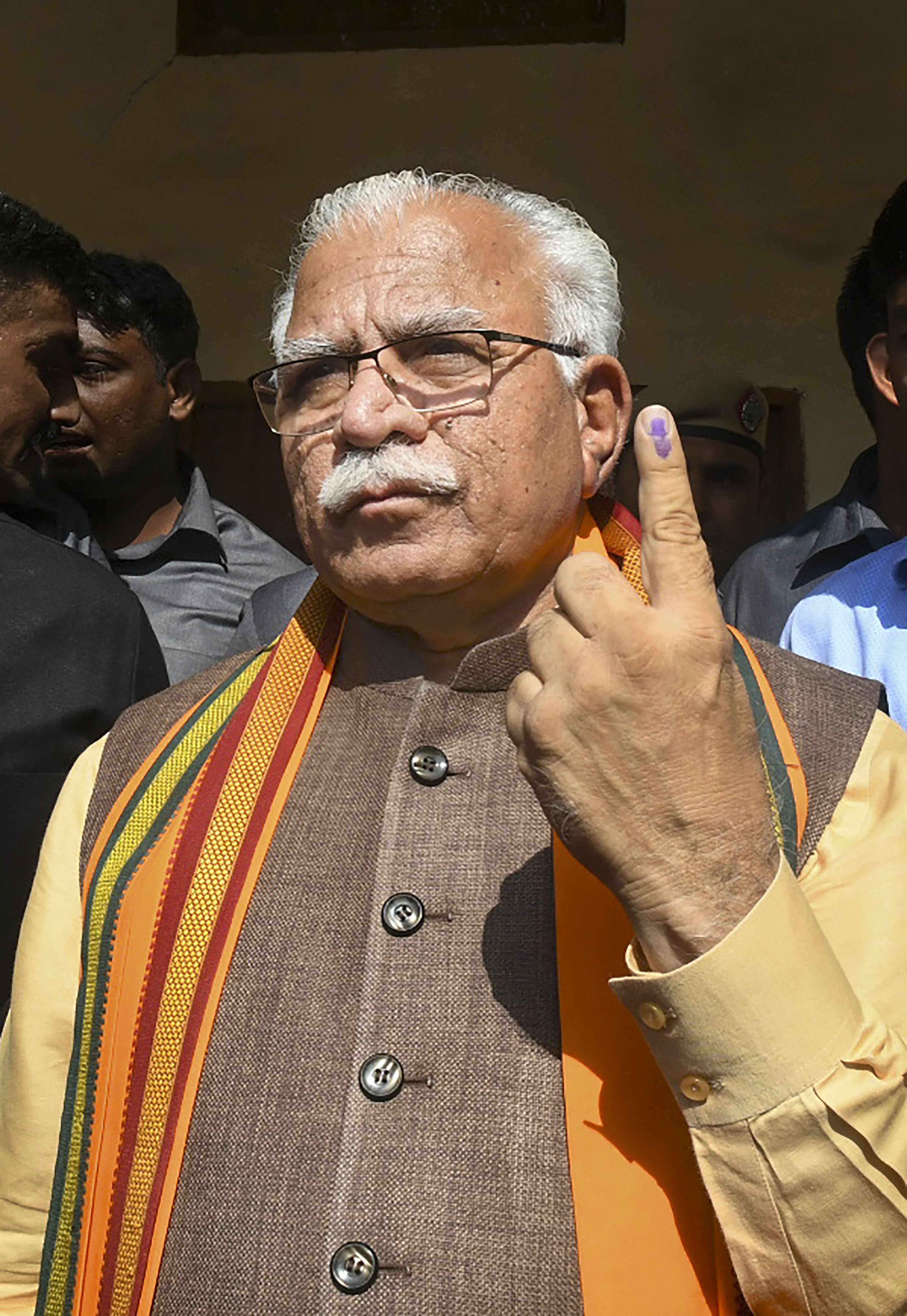 Haryana chief minister Manohar Lal Khattar shows his finger marked with indelible ink after casting his vote during the Haryana Assembly elections, in Karnal district, Monday, October 21, 2019.