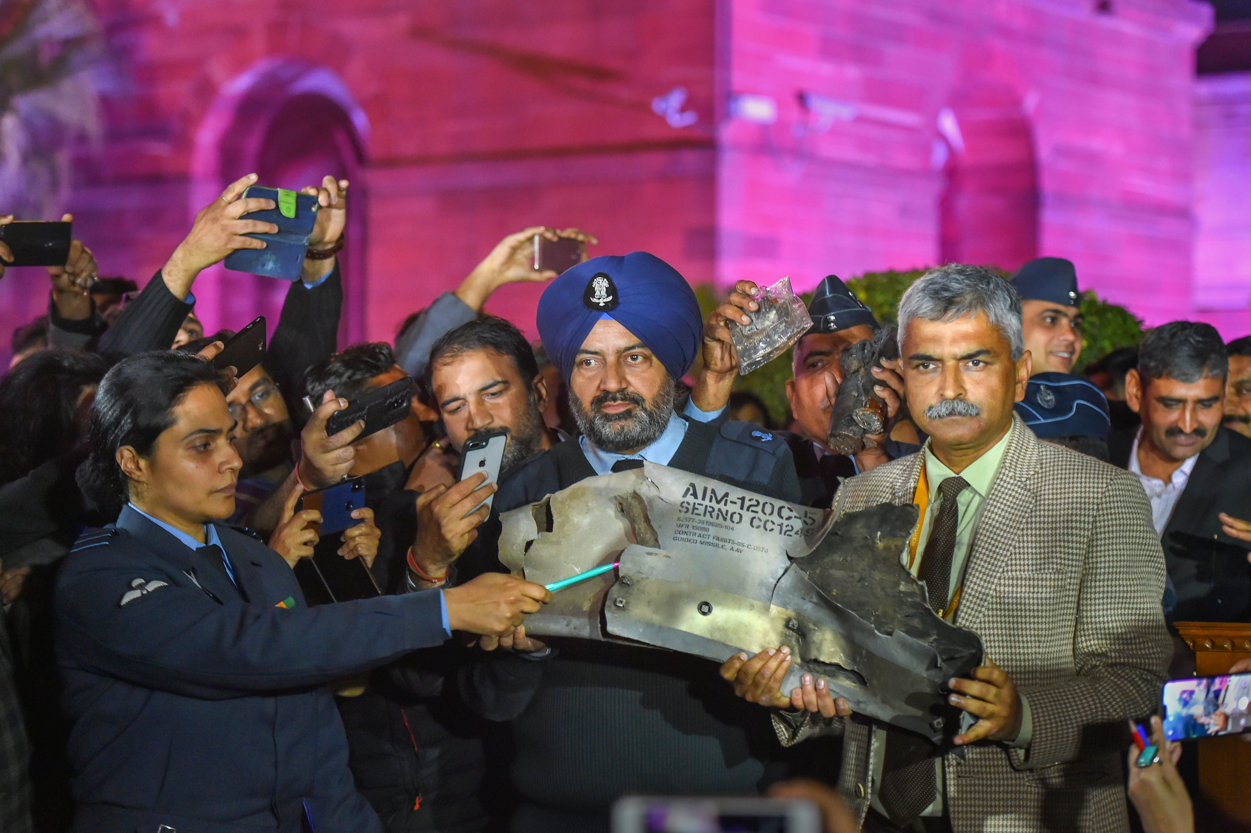 Indian military officials show sections of an exploded AMRAAM missile, said to be fired by Pakistan Air Force F-16s. 