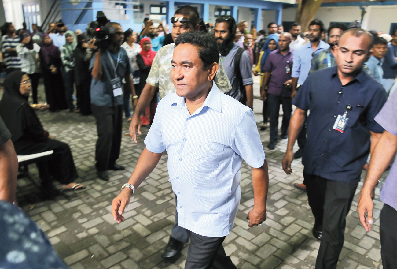 Maldivian President Yameen Abdul Gayoom leaves a polling station after casting his vote in Male on September 23. 
