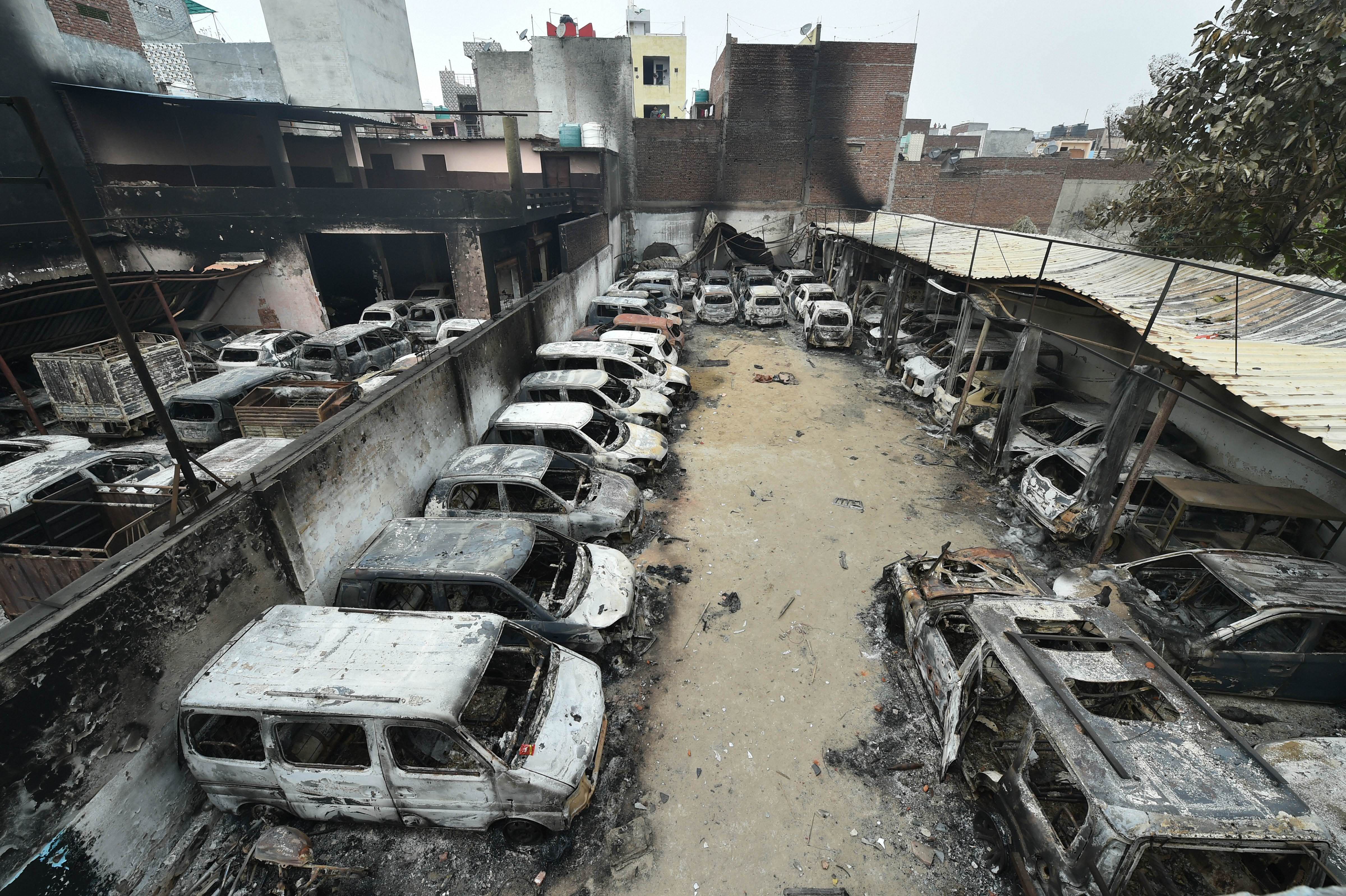 Charred remains of vehicles set ablaze by rioters during communal violence over the amended citizenship law, at Shivpuri area of north east Delhi, Thursday, February 27, 2020