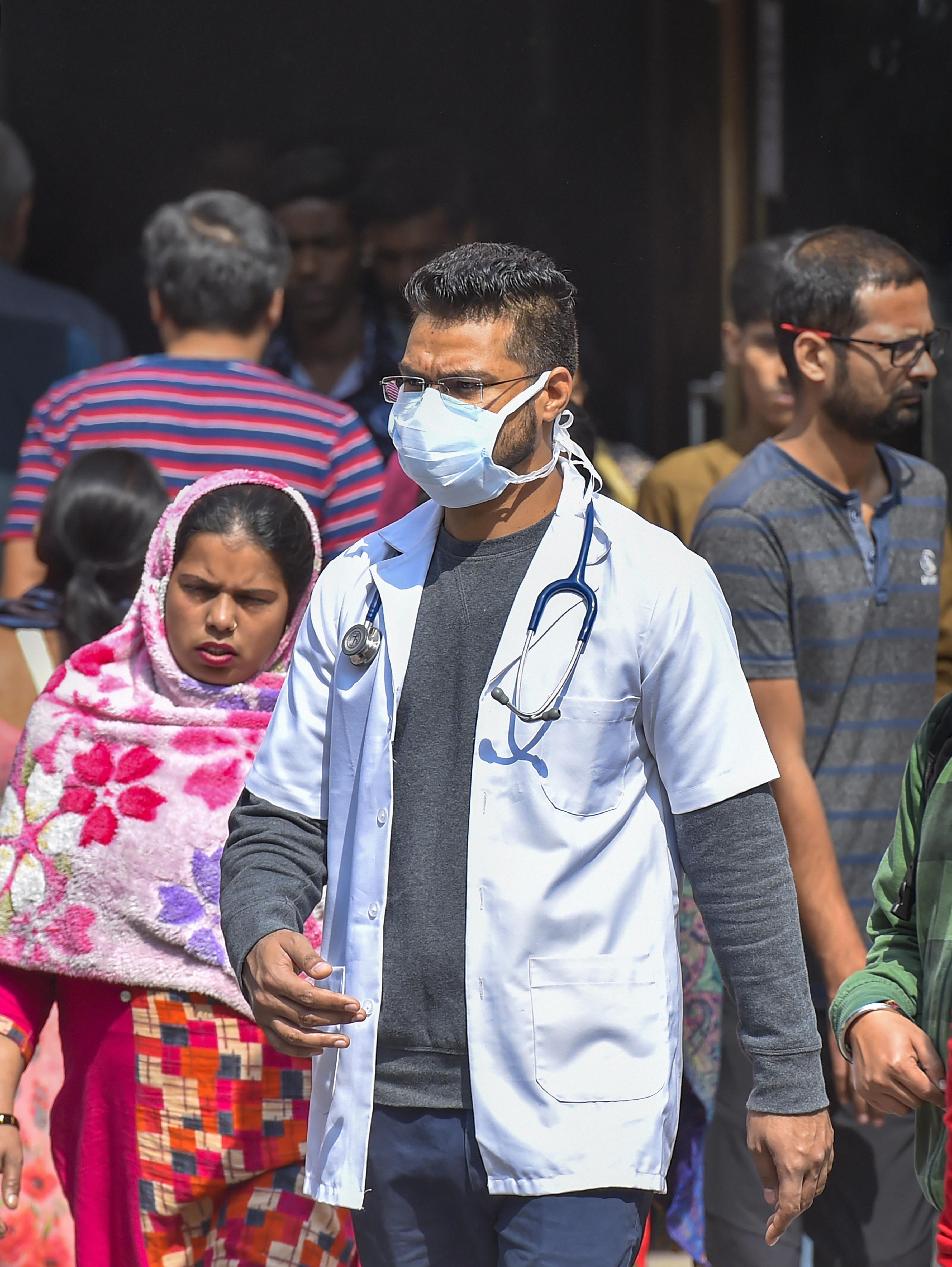 A medic wearing a protective mask in the wake of novel coronavirus or COVID-19 outbreak, walks out of RML Hospital in New Delhi, Tuesday, March 3, 2020