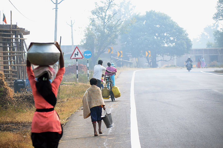 Dhankachda residents carry water containers on Ranchi-Pithoria Road in Kanke on Wednesday. 