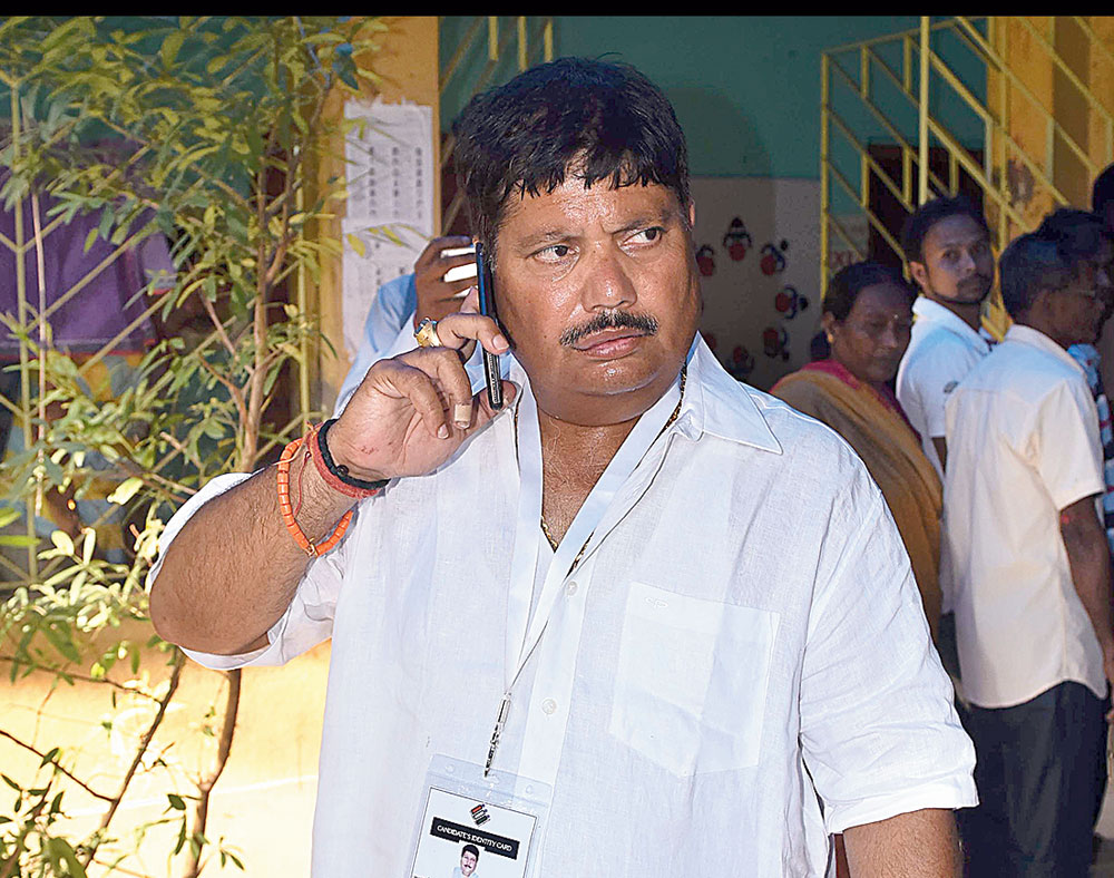 Arjun Singh talks over the phone during the voting;