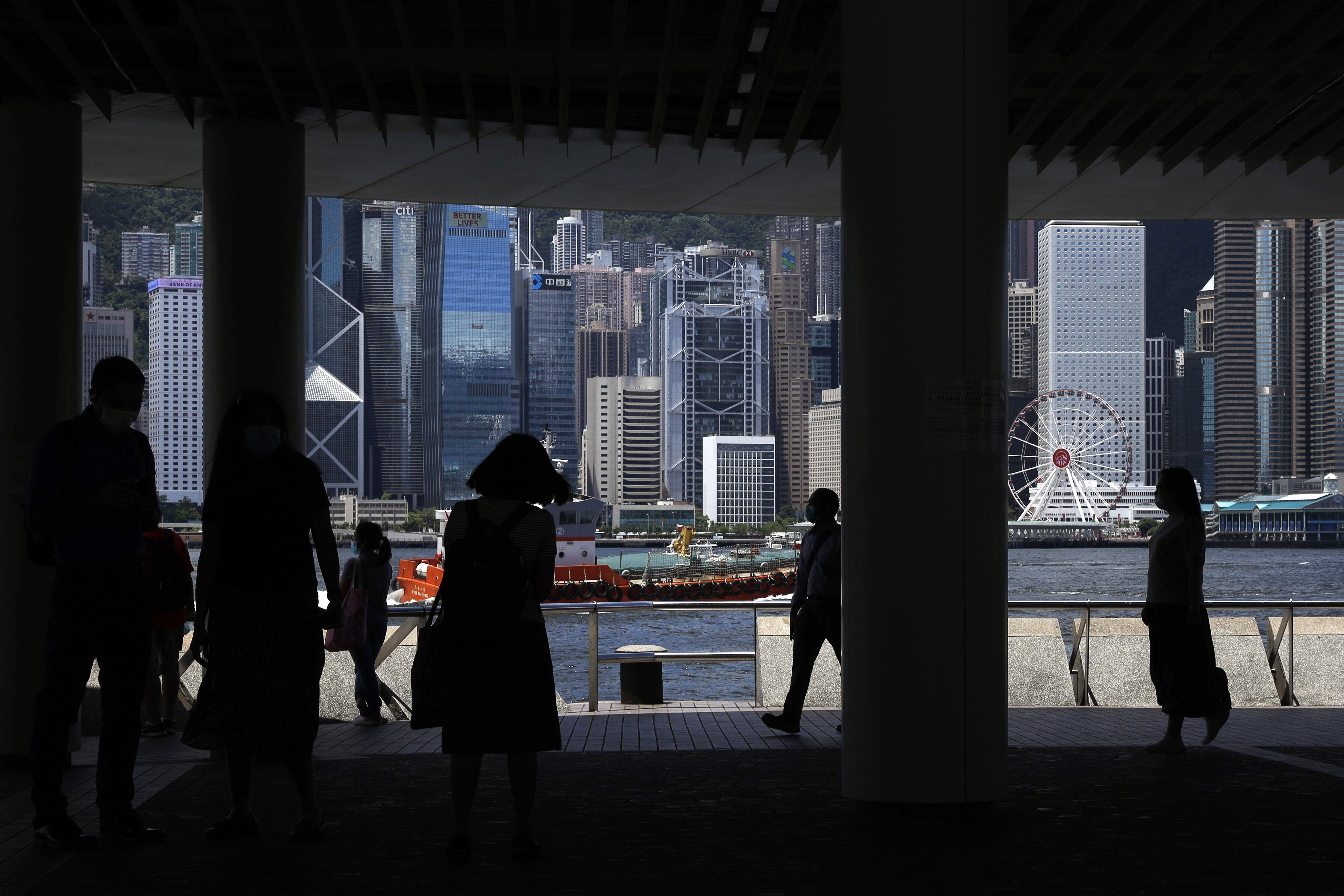 People walk at the waterfront of the Victoria Harbor of Hong Kong on Saturday