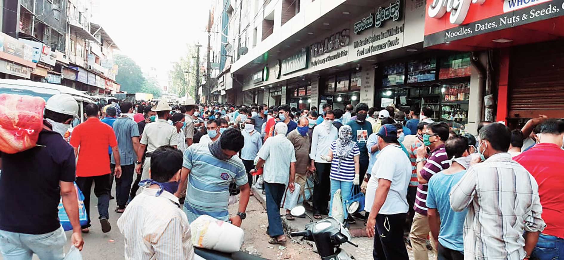 Residents throng a market in Mangalore on Tuesday after the administration relaxed the lockdown for nine hours
