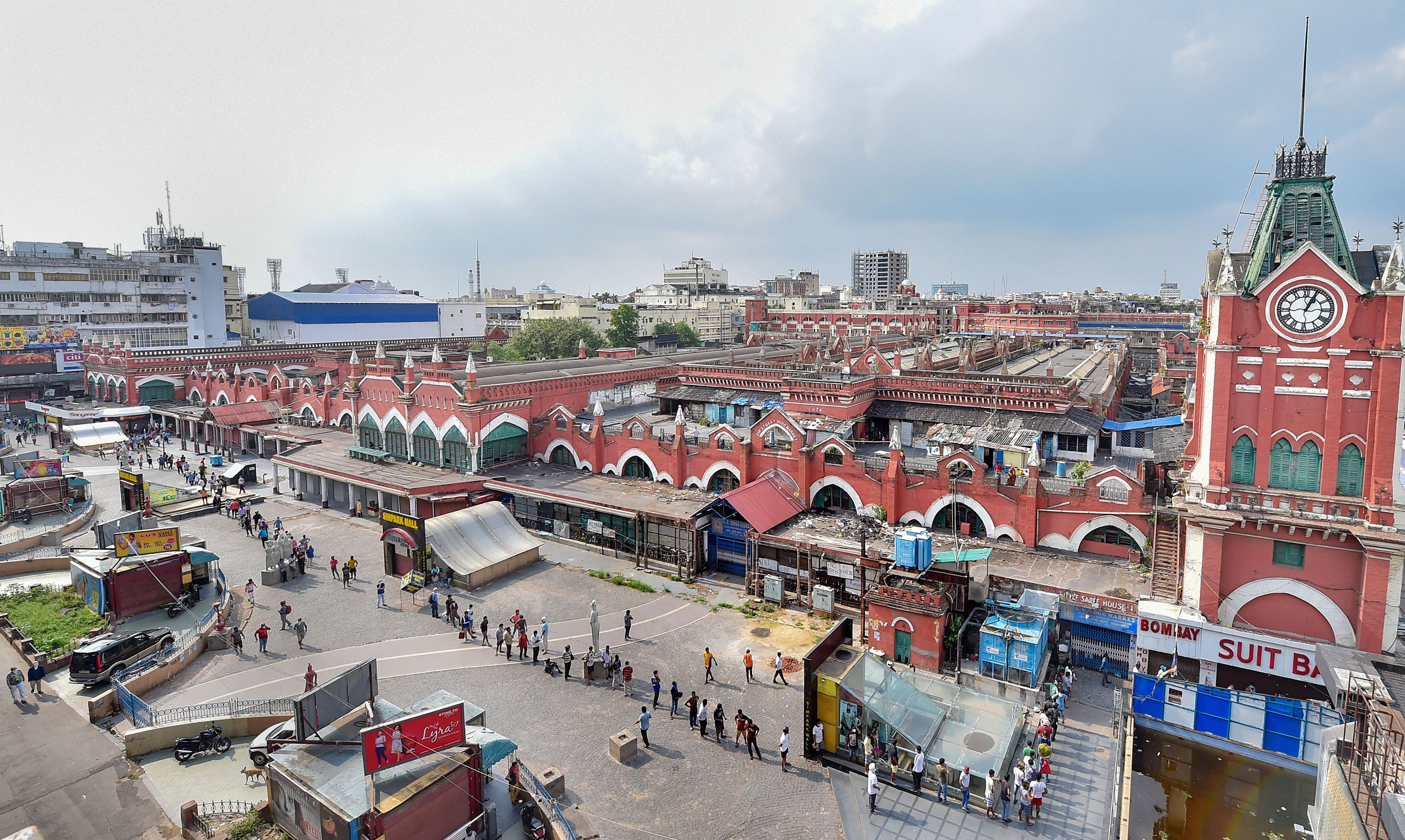 People stand in a long queue to purchase liquor from a shop at New Market area, amid ongoing Covid-19 lockdown in Kolkata, Monday, May 4, 2020.