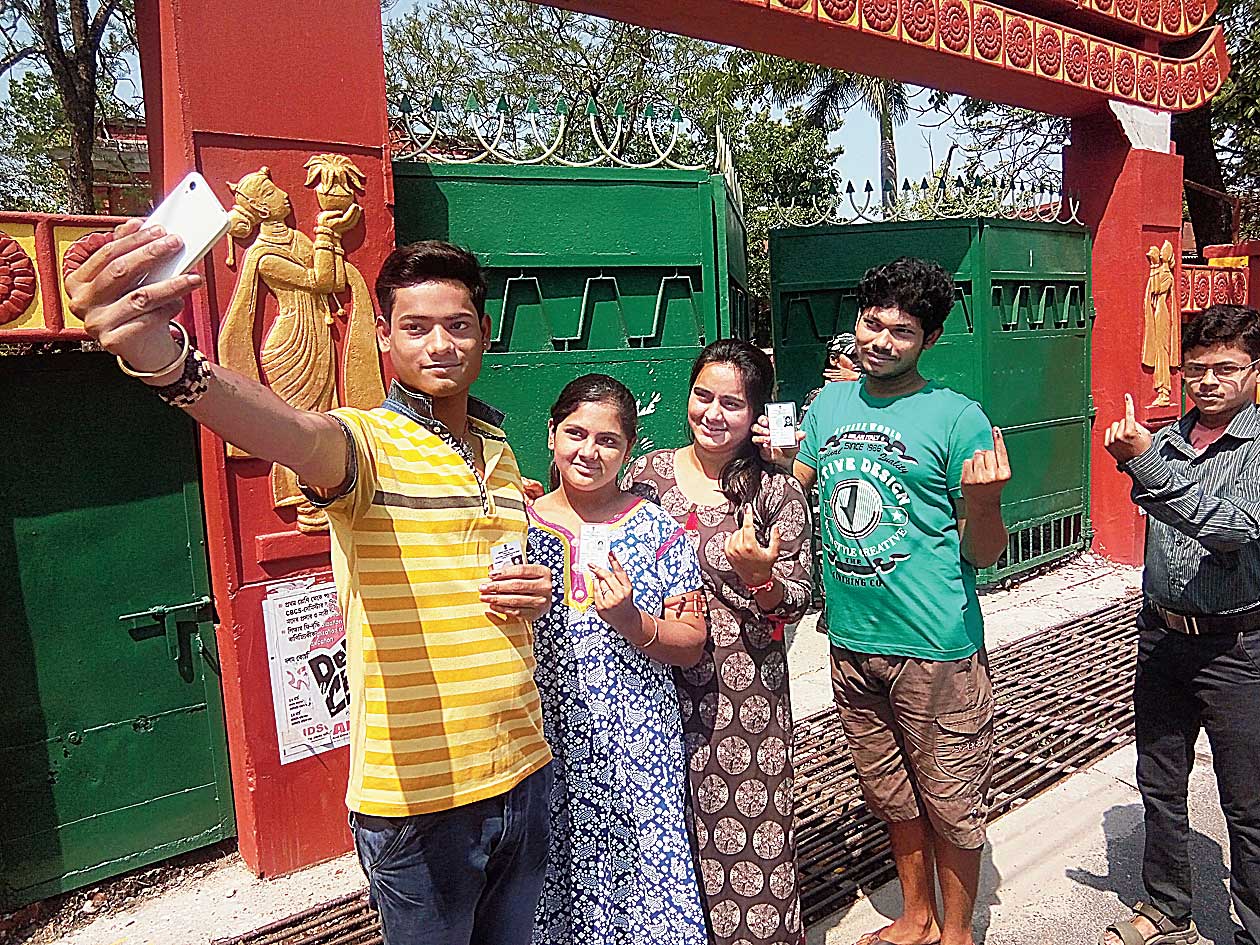 A boy takes a selfie near a booth in Cooch Behar on Thursday.
