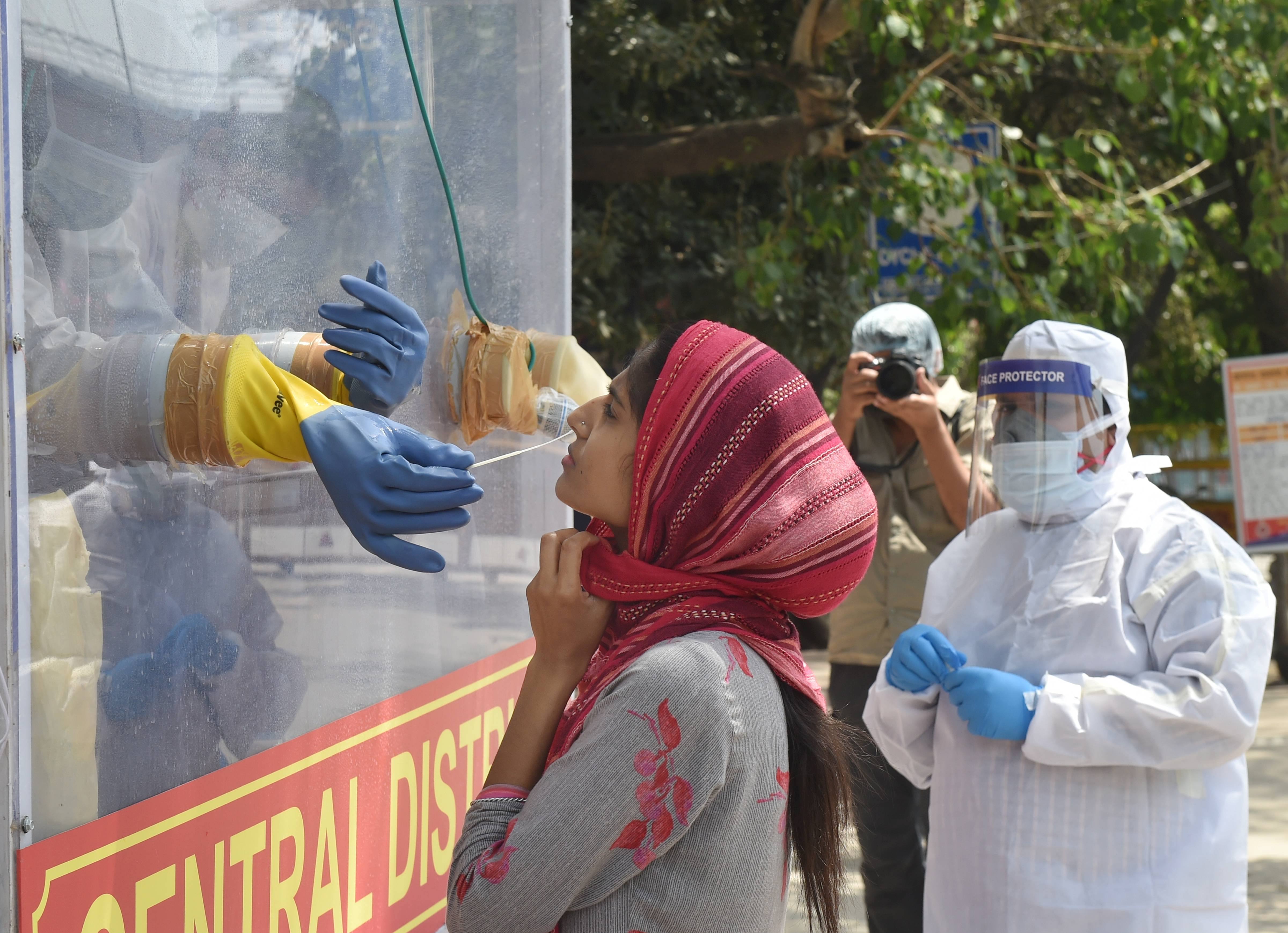 A medics collects samples for swab tests from a Covid-19 mobile testing van, during the nationwide lockdown to curb the spread of coronavirus, at Ramakrishna Mission area in New Delhi, Saturday, May 2, 2020.