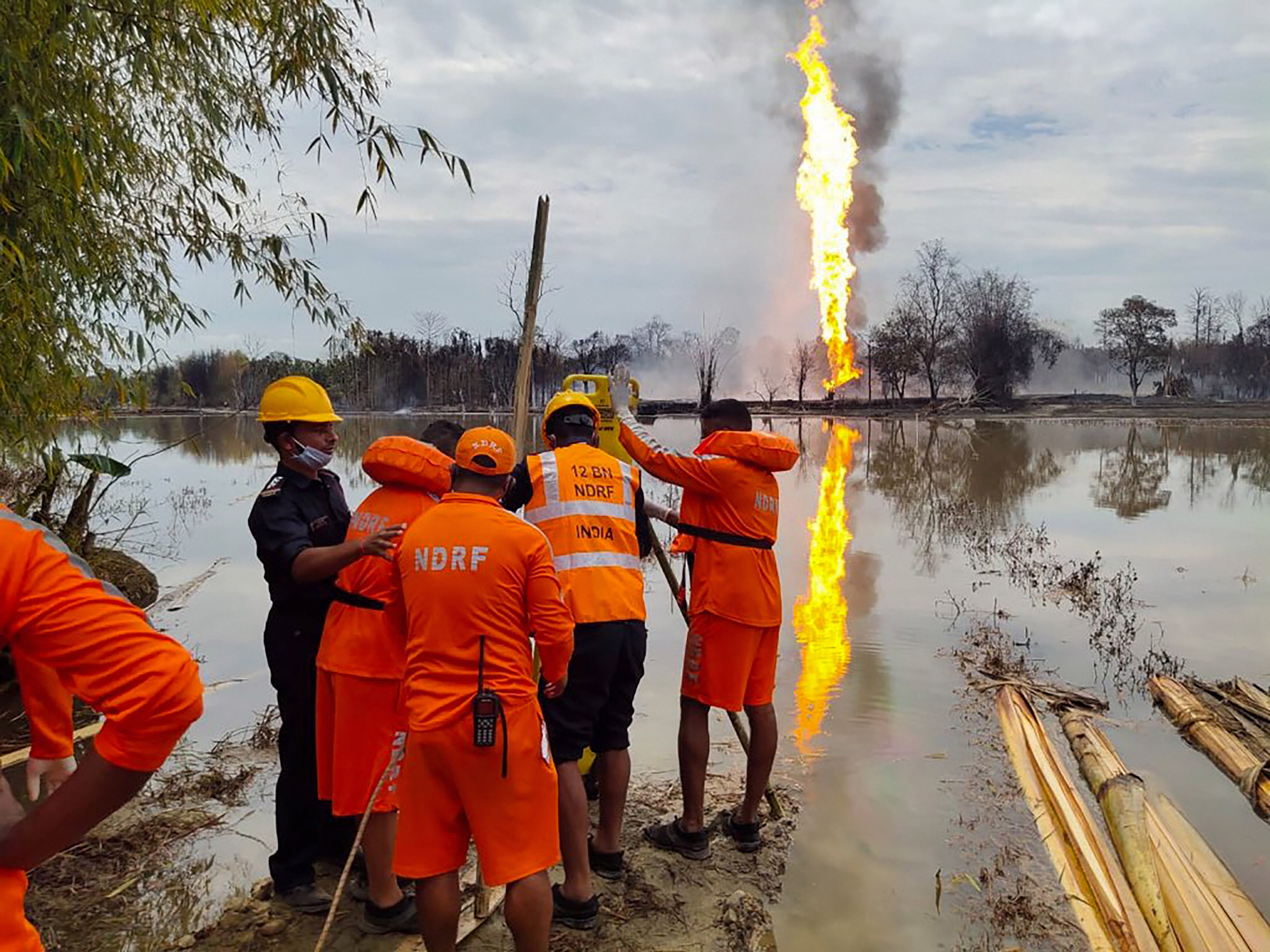 National Disaster Response Team (NDRF) personnel carry out search and rescue operations after two firemen of Oil India Limited went missing since an oil well at the company’s Baghjan oilfield exploded in Assam’s Tinsukia district.