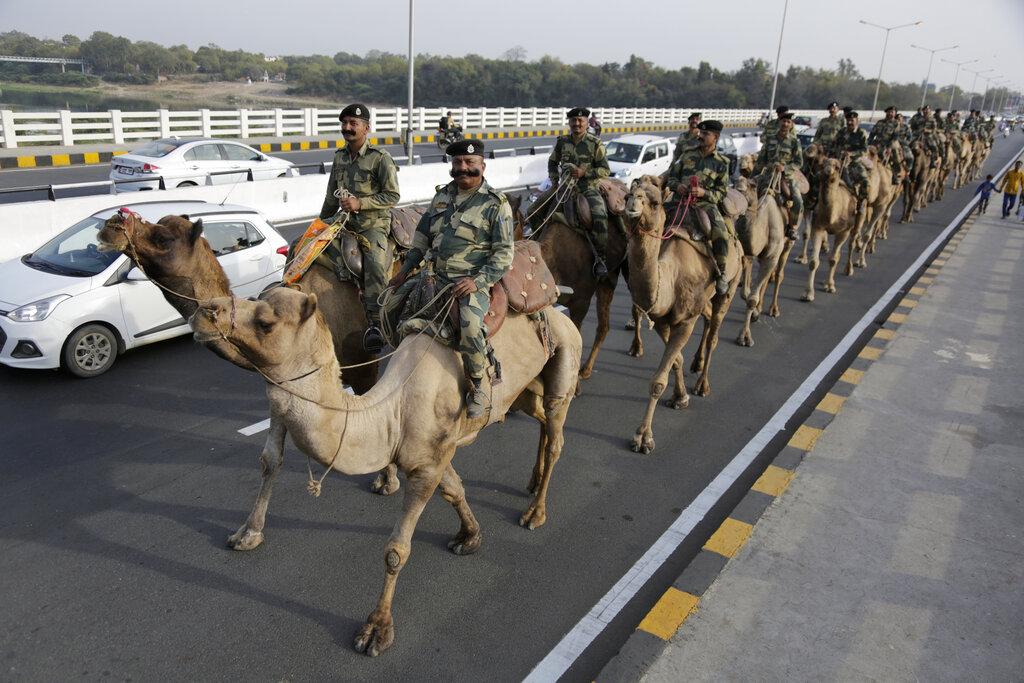 Border Security Force(BSF) soldiers march on the route that U.S. President Donald Trump will take in Ahmedabad. A festive mood has enveloped Ahmedabad in India’s northwestern state of Gujarat ahead of Prime Minister Narendra Modi's meeting Monday with U.S. President Donald Trump, whom he's promised millions of adoring fans. The rally in Modi's home state may help replace his association with deadly anti-Muslim riots in 2002 that landed him with a U.S. travel ban. Beyond the pageantry and symbolism of the visit, experts expect little to be achieved for either side.