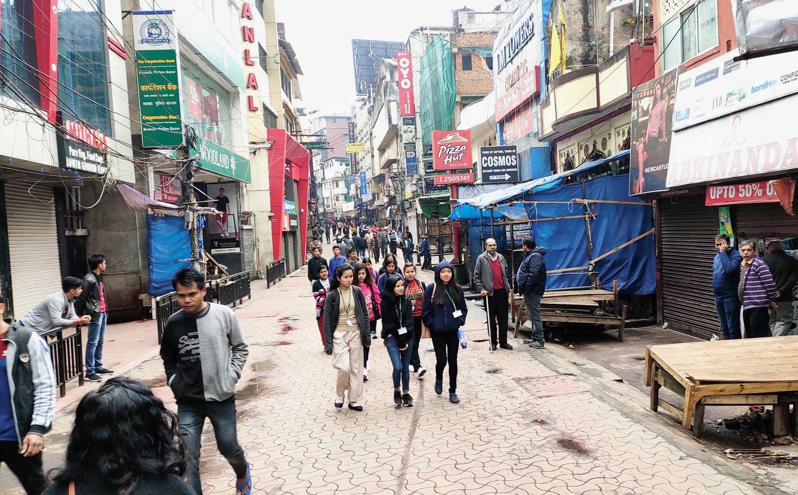 People walk though Police Bazaar during curfew relaxation in Shillong on Tuesday. 

