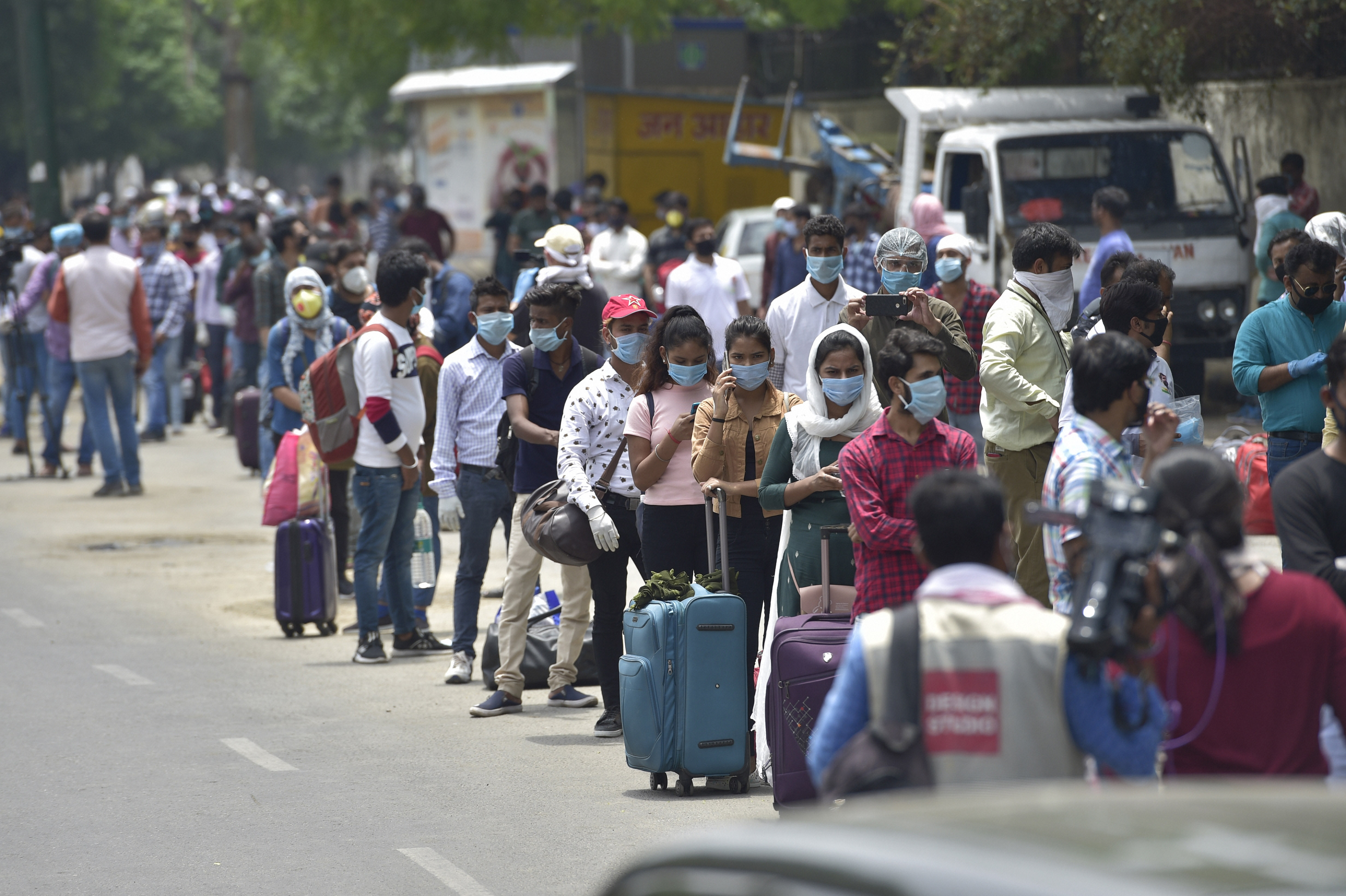 People wait to enter New Delhi Railway Station following resumption of passenger train services connecting major cities, during the ongoing Covid-19 nationwide lockdown, in New Delhi, Tuesday, May 12, 2020