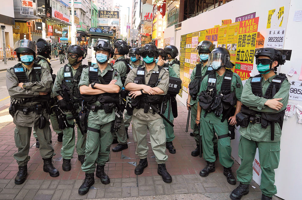 Police officers stand guard during a pro-democracy rally in Hong Kong on Sunday. 