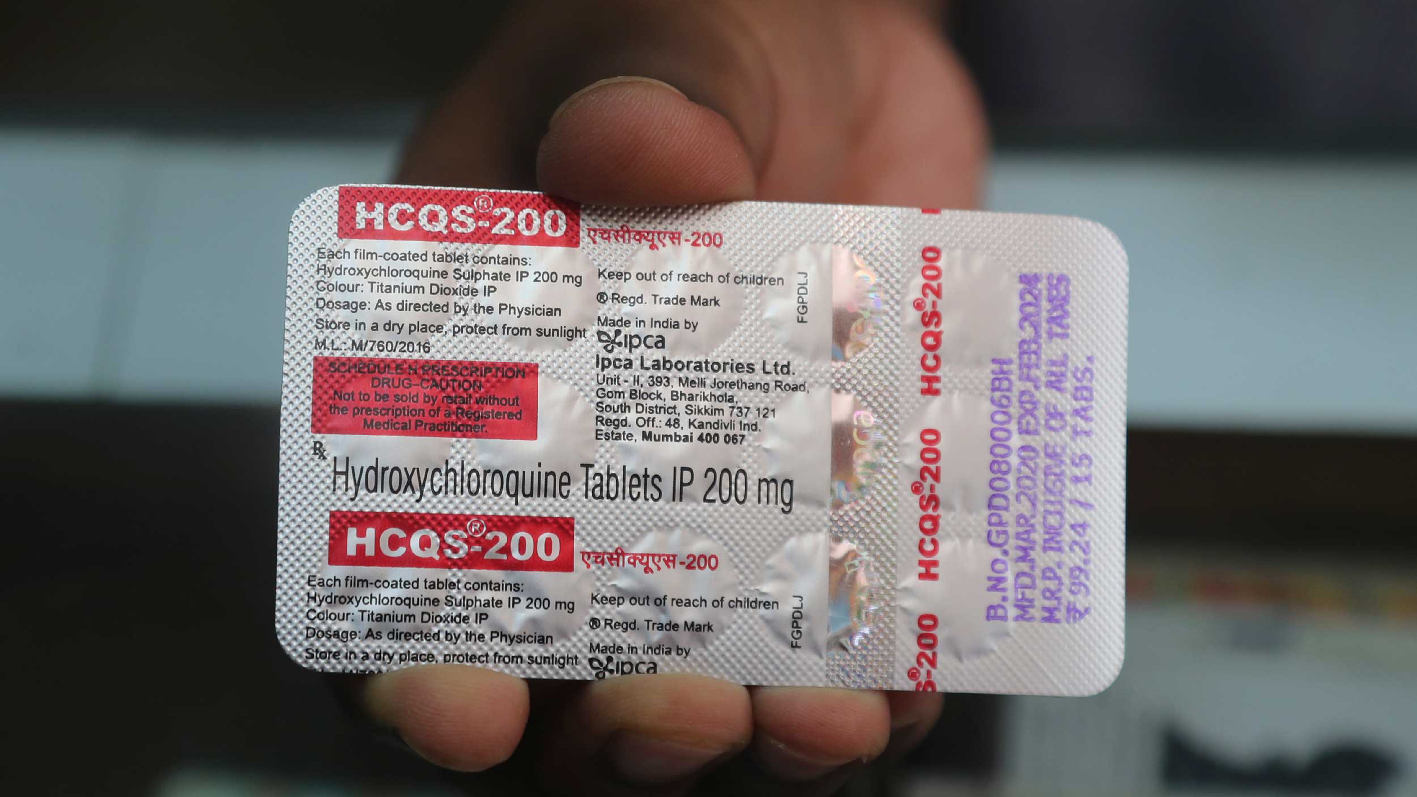A chemist displays hydroxychloroquine tablets in Mumbai.
