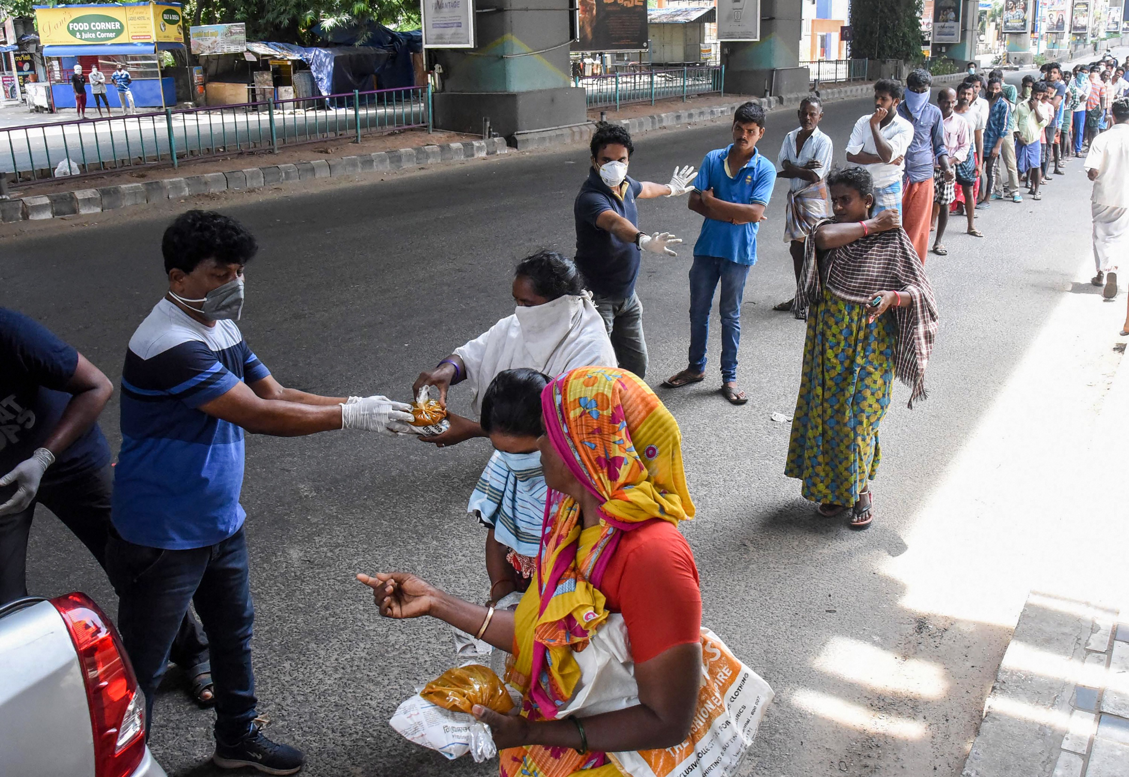 Social workers distribute food packets among the needy people during the nationwide lockdown imposed to contain the spread of coronavirus, in Kochi, Monday, April 6, 2020.