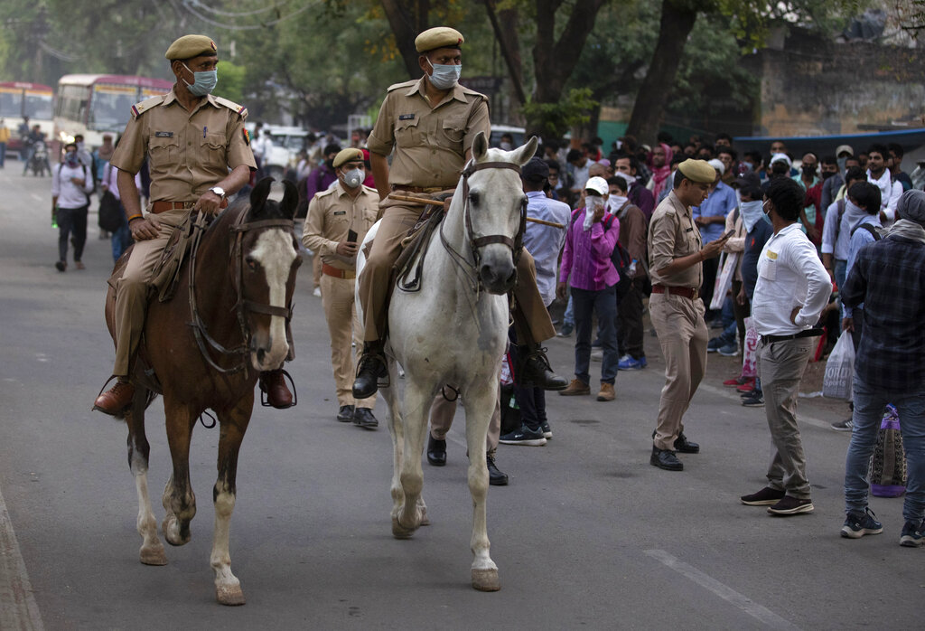 Police officials patrol as stranded students from various districts wait for transport to travel to their hometowns, during the lockdown imposed to prevent the spread of coronavirus in Prayagraj, Tuesday, April 28, 2020.