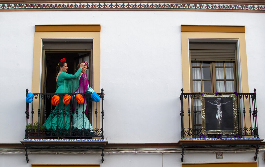 Women in traditional dress dance on their decorated balcony in the village of Mairena del Alcor, some 21 kilometres (13 miles) from Seville during the annual traditional April Fair celebrated across the southern Andulacia Provence. Without breaking the confinement rules, the residents of the village have found a novel way of continuing the tradition of the fair which has been cancelled due to the coronavirus outbreak and normally includes flamenco dancing, bullfighting, eating and drinking.