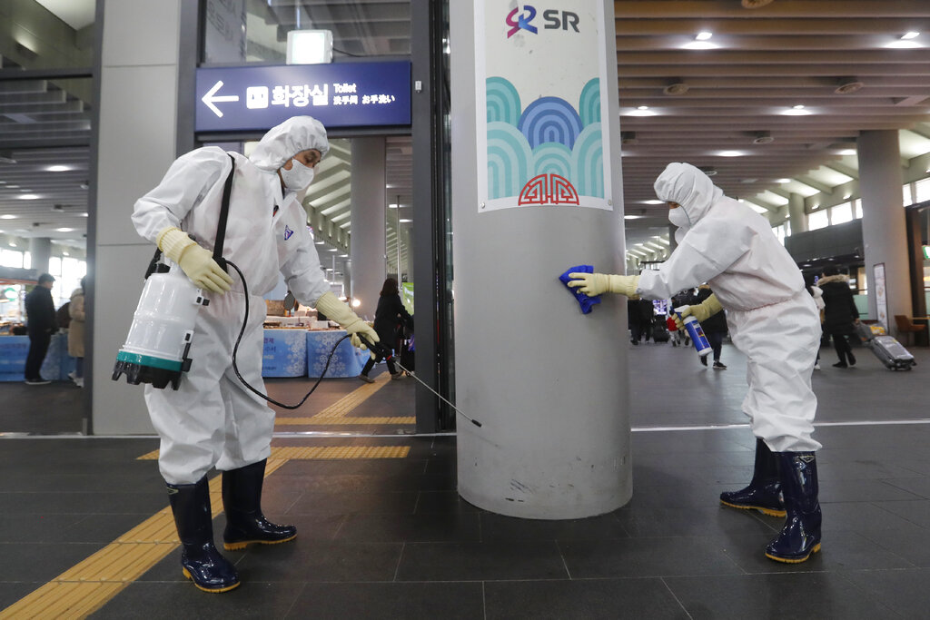 Employees work to prevent a new coronavirus at Suseo Station in Seoul, South Korea, Friday, January 24, 2020
