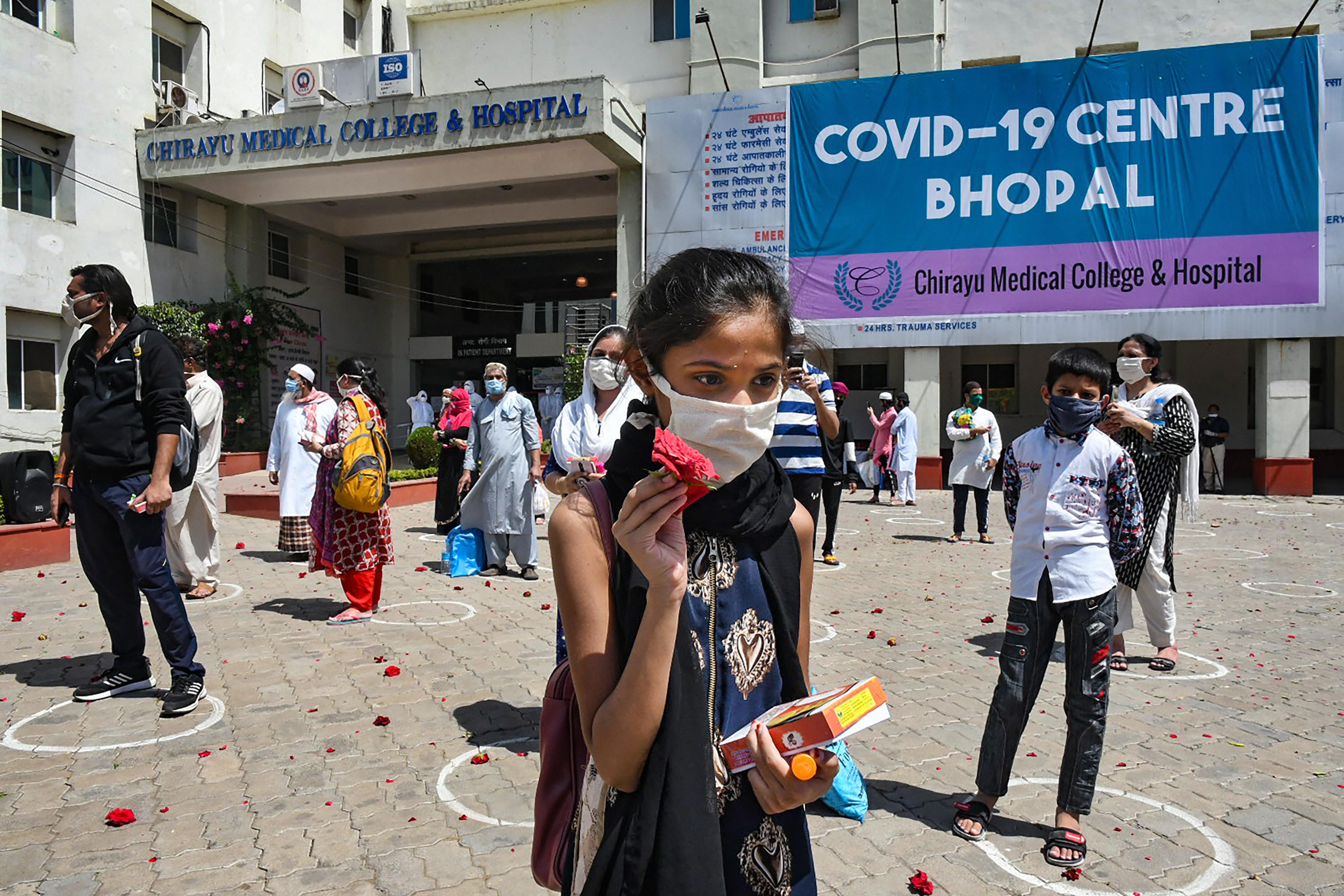 An Army bank welcomes people who recovered from Covid-19 while they are discharged from the Chirayu Hospital in Bhopal, Sunday, May 3, 2020.