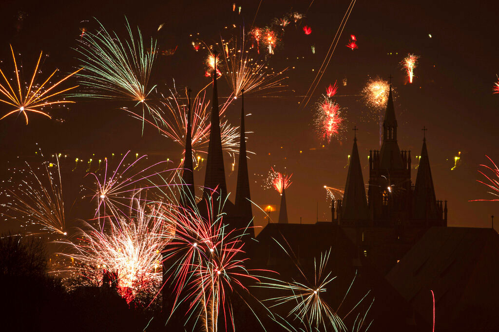 Fireworks light the sky above the St. Severi's Church and the Mariendom (Cathedral of Mary) during New Year's celebrations in Erfurt, central Germany, on Wednesday.