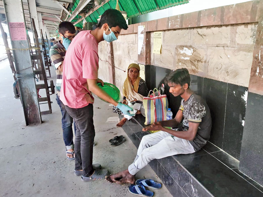 Volunteers distribute food to the poor