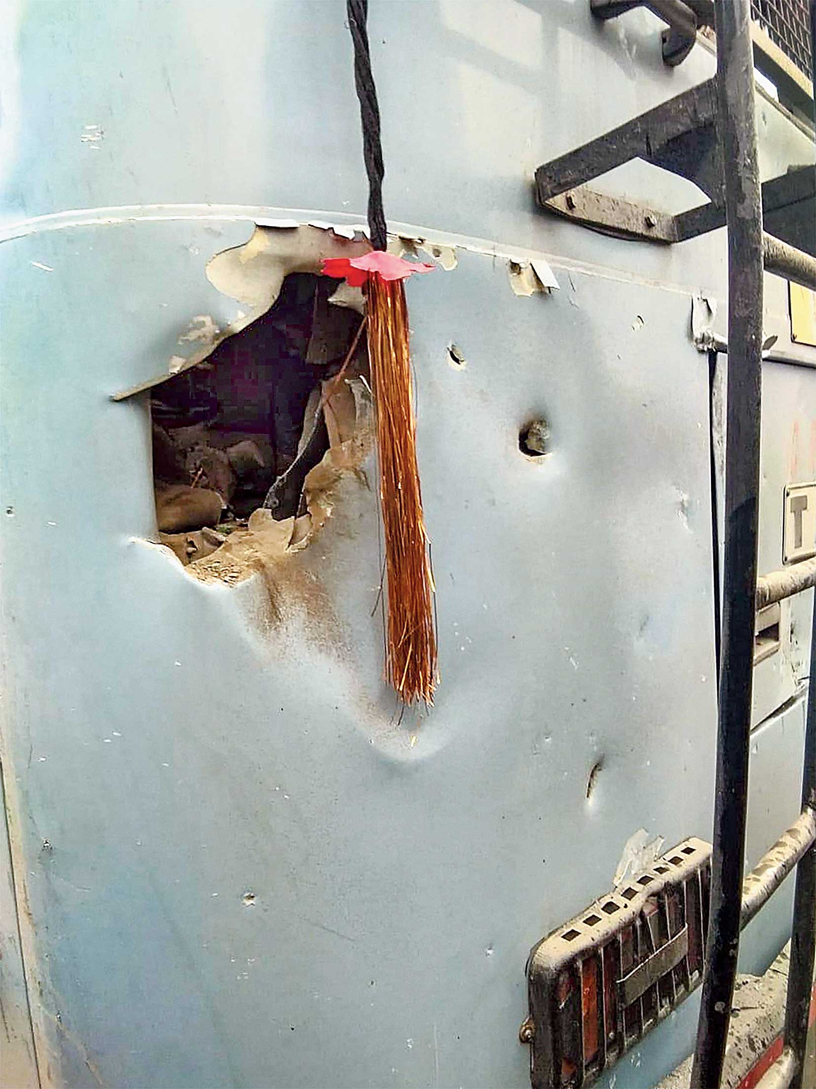 A deep gash on a bus shows the impact of the explosion. 