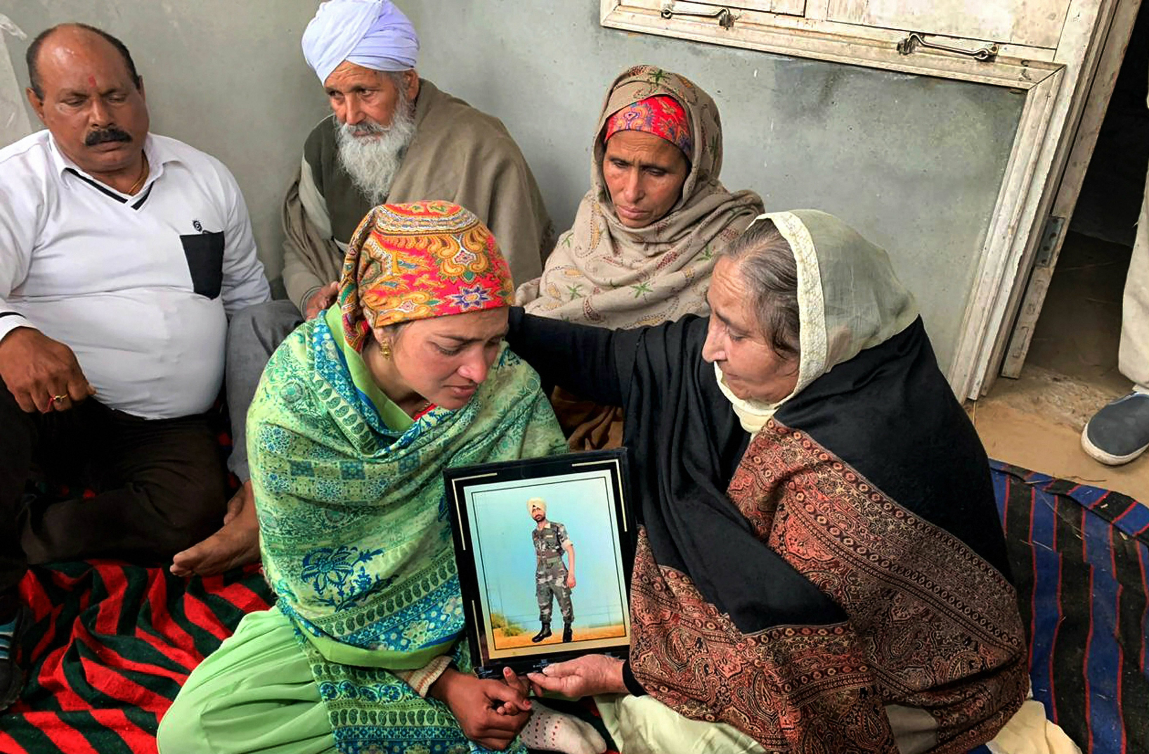 Family members mourn the death of CRPF jawan Sukhjinder Singh at his home in Gandiwind Dhattal village in Punjab's Tarn Taran district, on Friday.