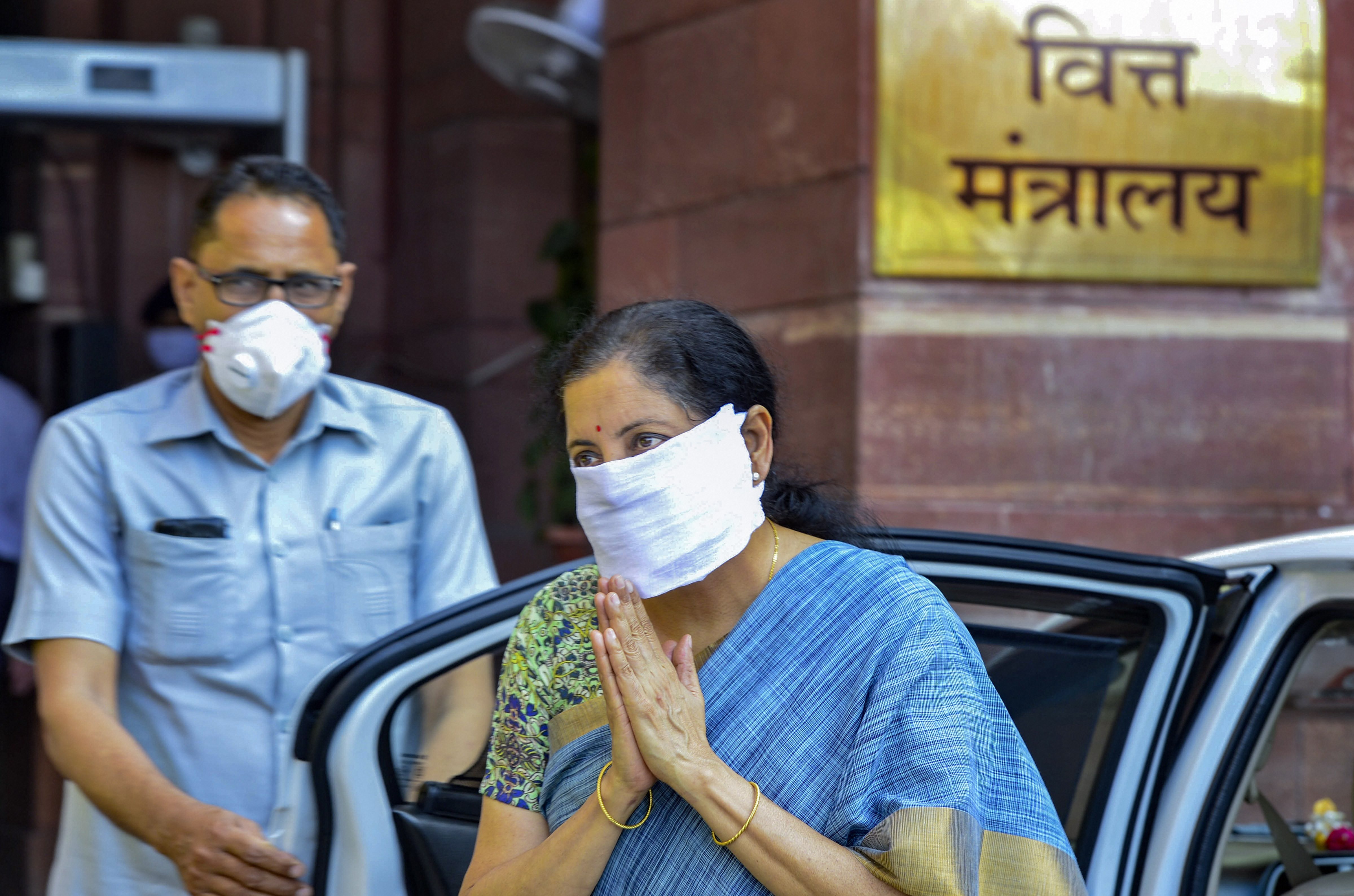 Nirmala Sitharaman wearing a home-made protective mask arrives to resume office in New Delhi on Monday. 