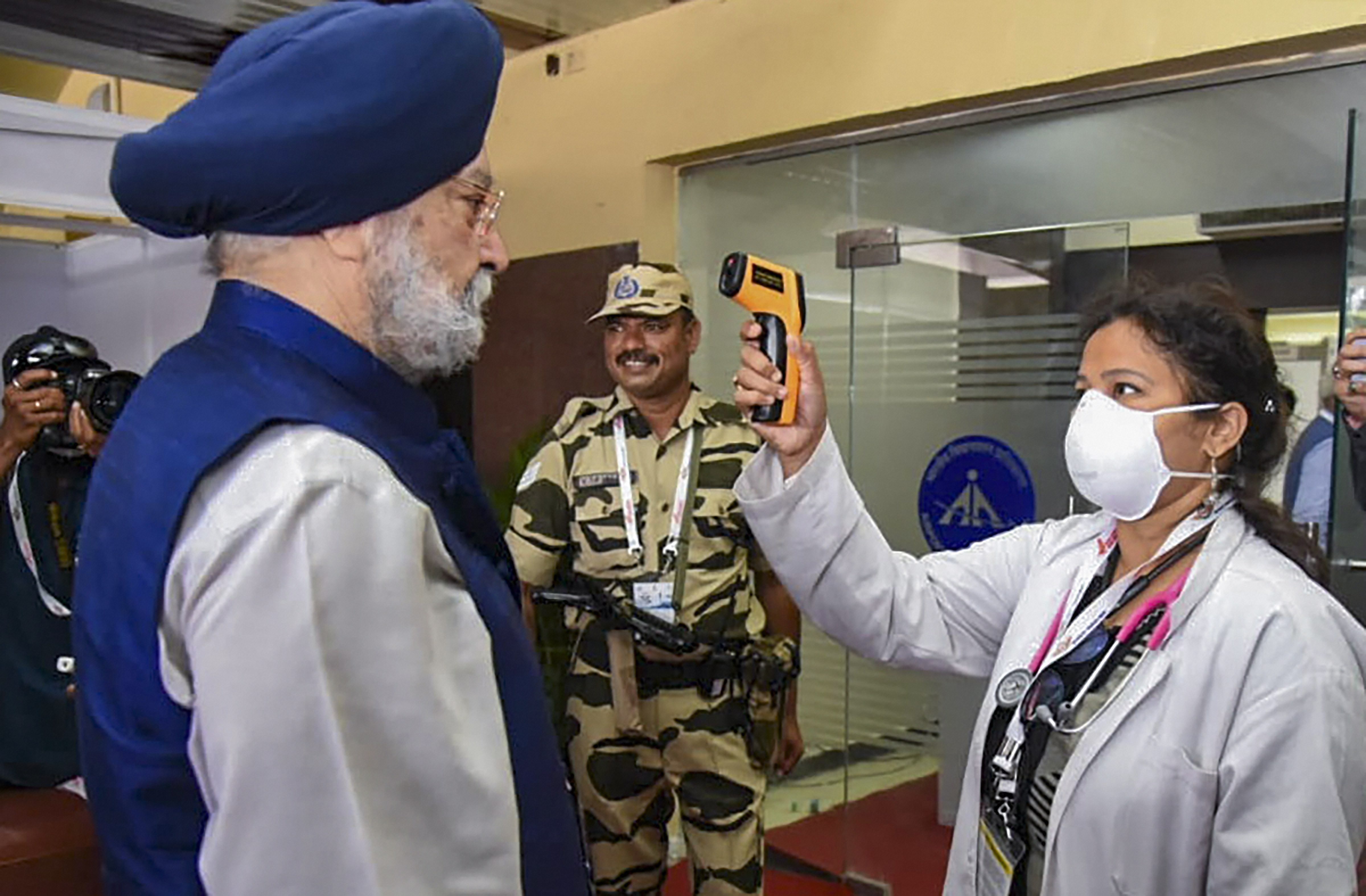 Minister of State for Housing & Urban Affairs, Civil Aviation (Independent Charge) and Commerce & Industry Hardeep Singh Puri being screened by a medic for novel coronavirus (COVID-19), in Hyderabad, Saturday, March 14, 2020.
