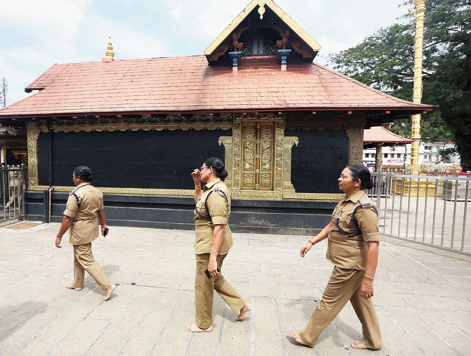 Policewomen over the age of 50 deployed at the Sabarimala temple circumambulate the main shrine on Monday, when it was opened for pilgrims for the second time since the Supreme Court verdict allowing women of all ages to enter.