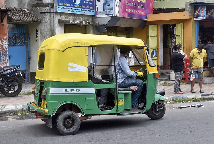 To each according to his ability. An auto makes a valiant attempt at social distancing by separating the driver and the passenger with a plastic sheet.