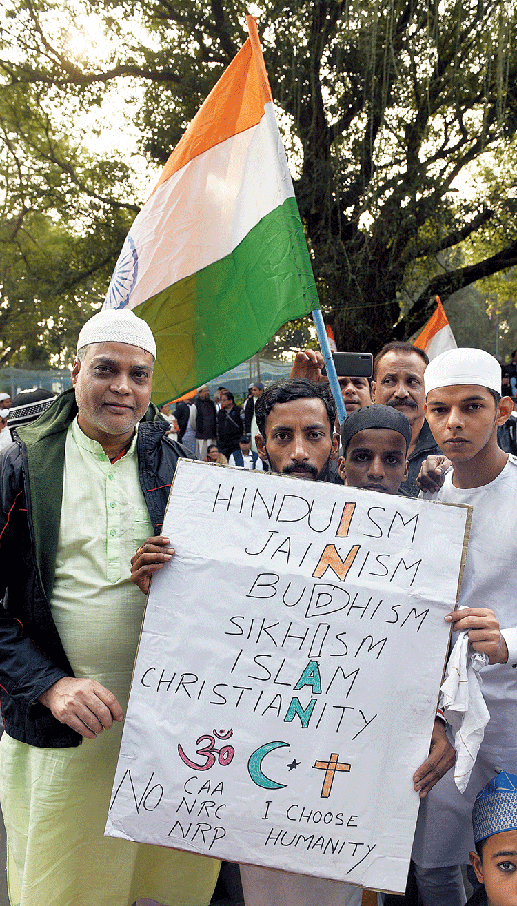 Santosh Rao (second from left) and Mohammad Shamir (extreme right), neighbours from Howrah’s Shibpur, came together with a poster. “We have grown up together and will continue to live here together, come what may,” said Rao, a trader