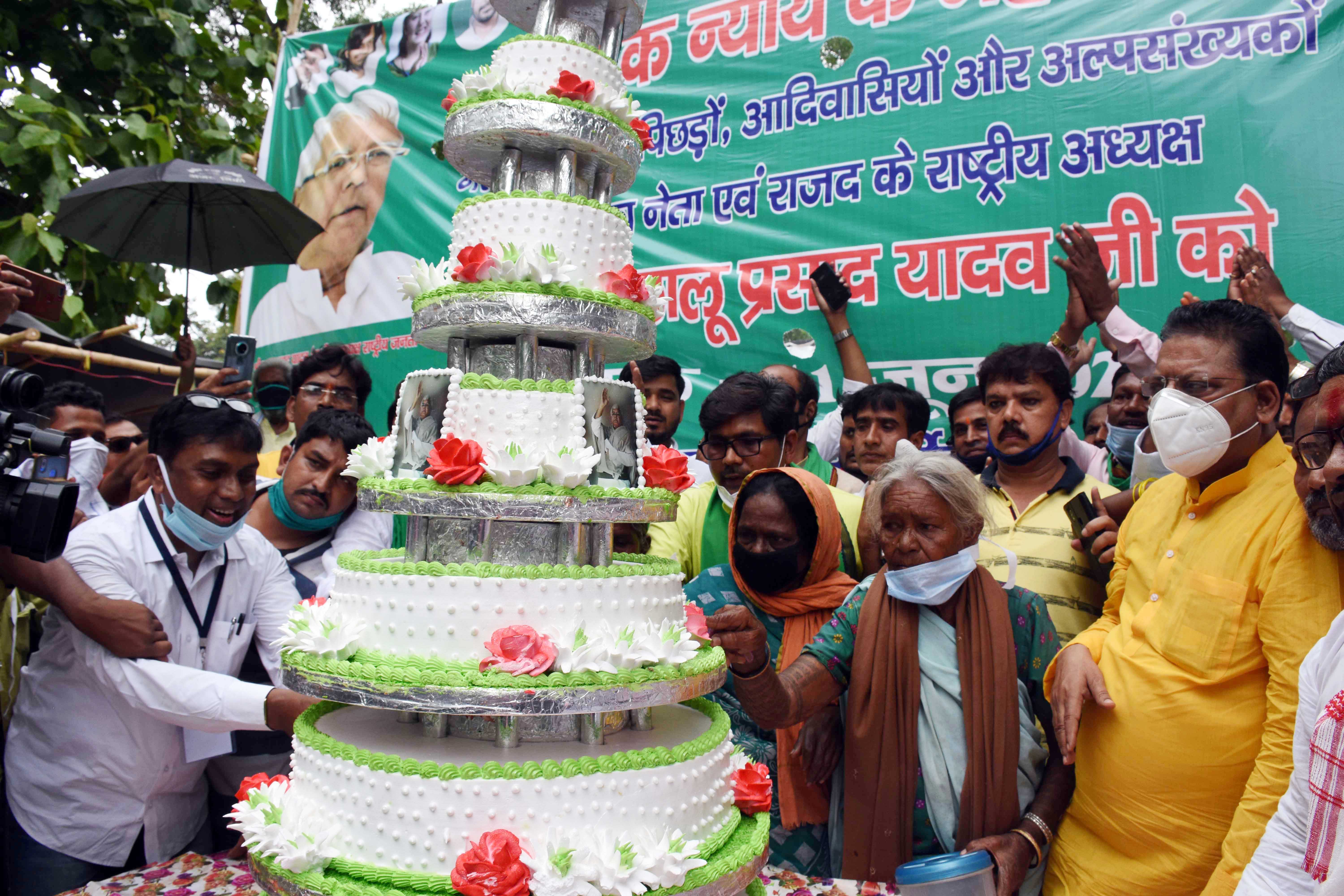 RJD workers and supporters celebrate Lalu Prasad's 73rd birthday at RIMS by cutting a 73-pound cake on RIMS campus in Ranchi on Thursday