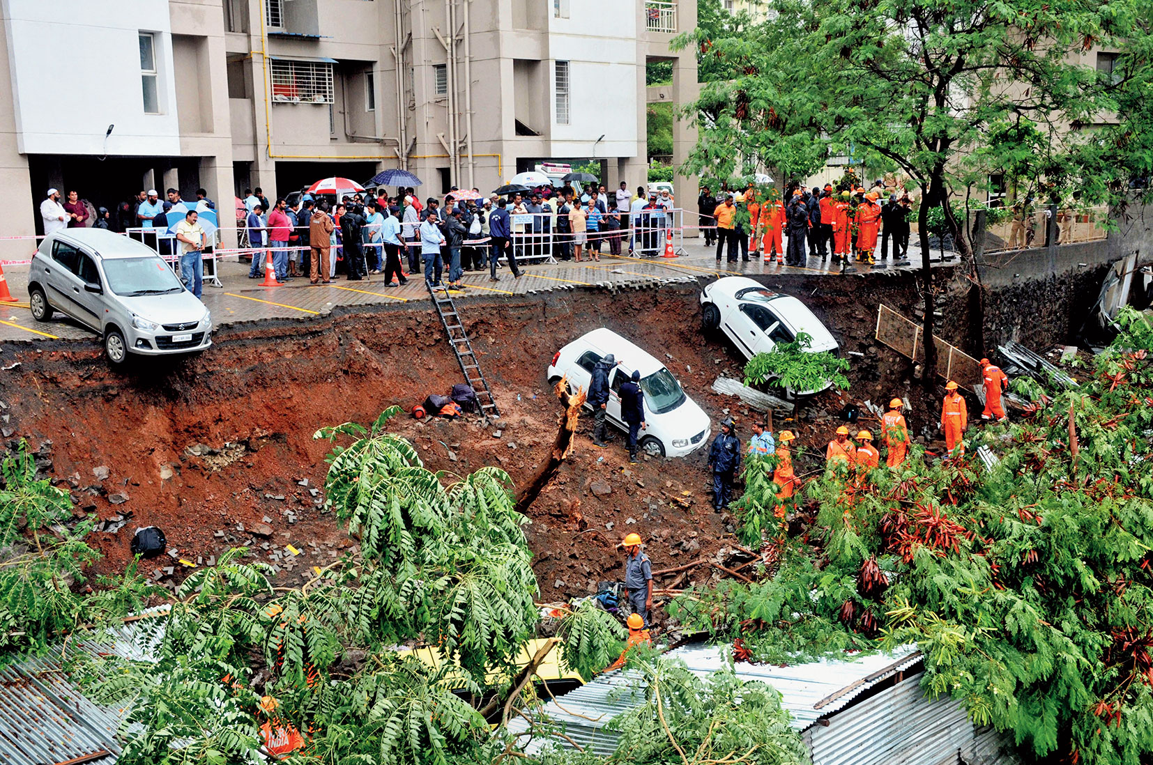 Some of the cars that were dislodged after the wall of the Pune housing society collapsed on the shanties in the adjoining property where a residential project is being built. Some cars also fell on the shanties. 