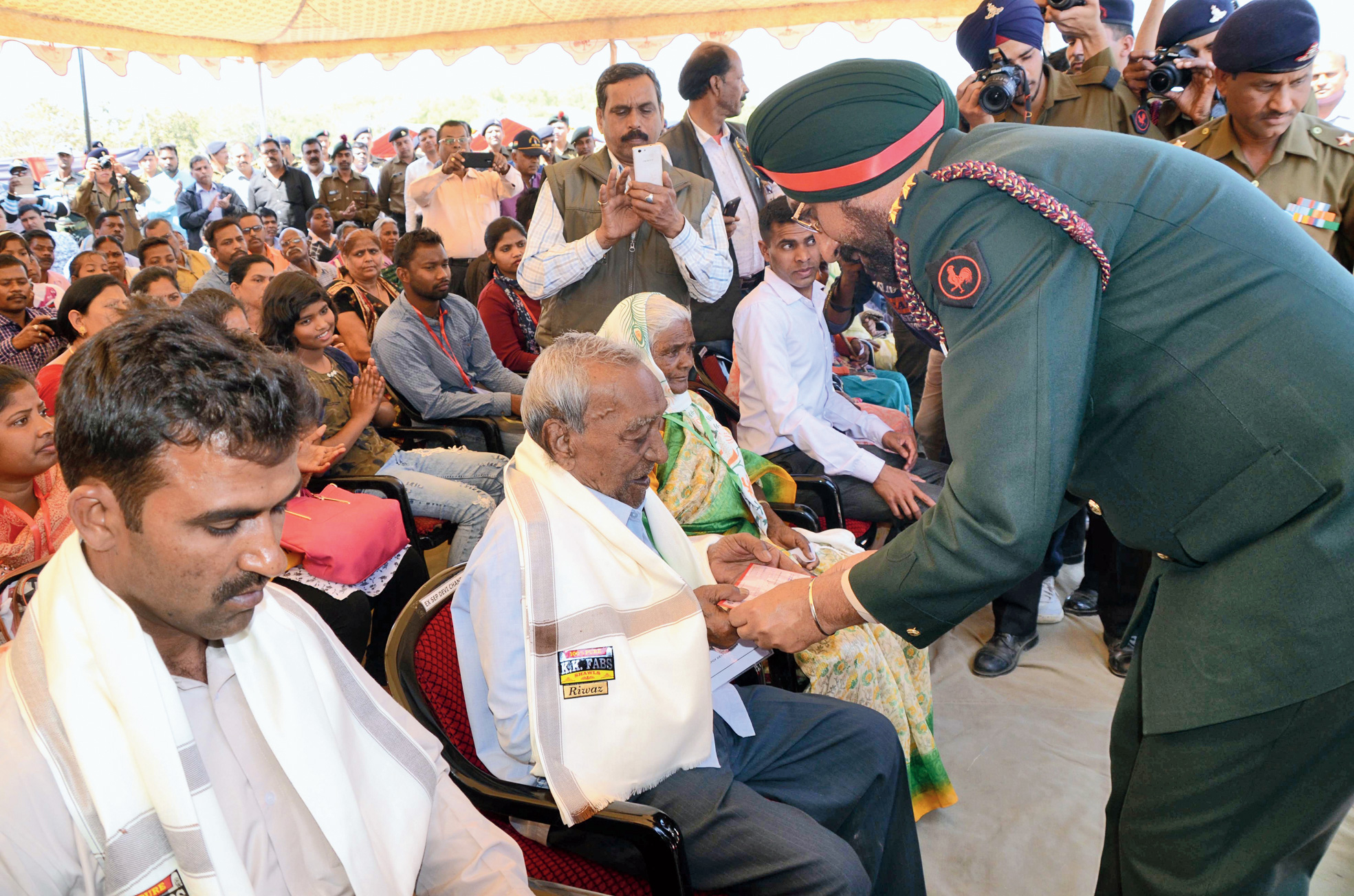 Brigadier IMS Parmar felicitates World War II veteran Devi Chandra.