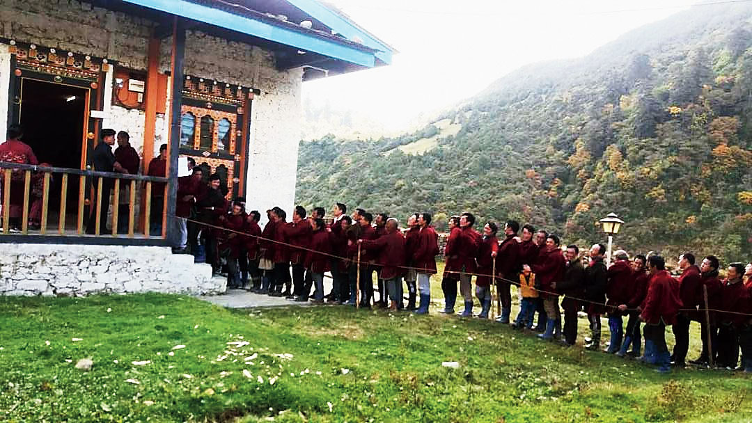 Voters stand in queue at a booth in Bhutan’s Phuentsholing on Thursday
