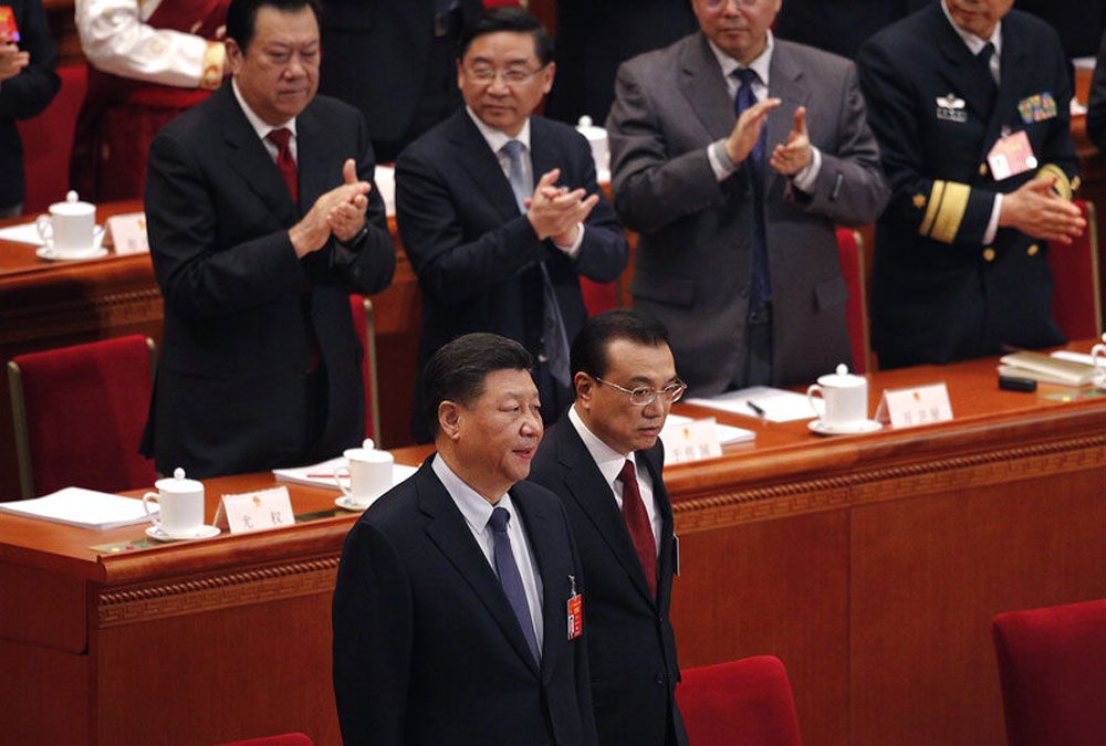 Chinese President Xi Jinping, left, and Chinese Premier Li Keqiang, right, at the opening session of China's National People's Congress at the Great Hall of the People in Beijing on Tuesday.