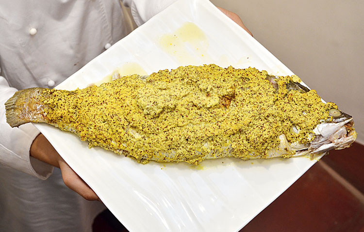 Bhetki Chingri Bhaape by Bikramjit Ray: Prawns marinated with mustard oil and salt were stuffed inside the bekti slathered with mustard and marinated in an oven for this dish that Bikramjit made for his parents’ birthday parties during his growing up years.