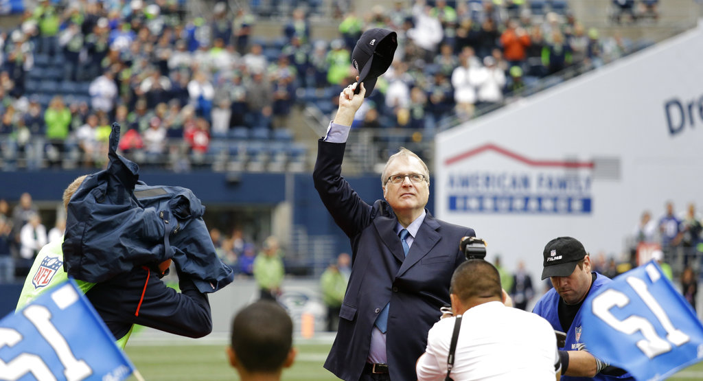 Paul Allen waves as he is honoured for his 20 years of ownership of Seattle Seahawks before an NFL football game against the San Francisco 49ers in Seattle on September 17, 2017.
