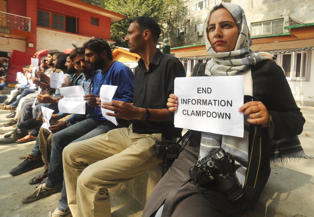 Kashmiri journalists display placards during a protest against the communication blackout in Srinagar on Thursday