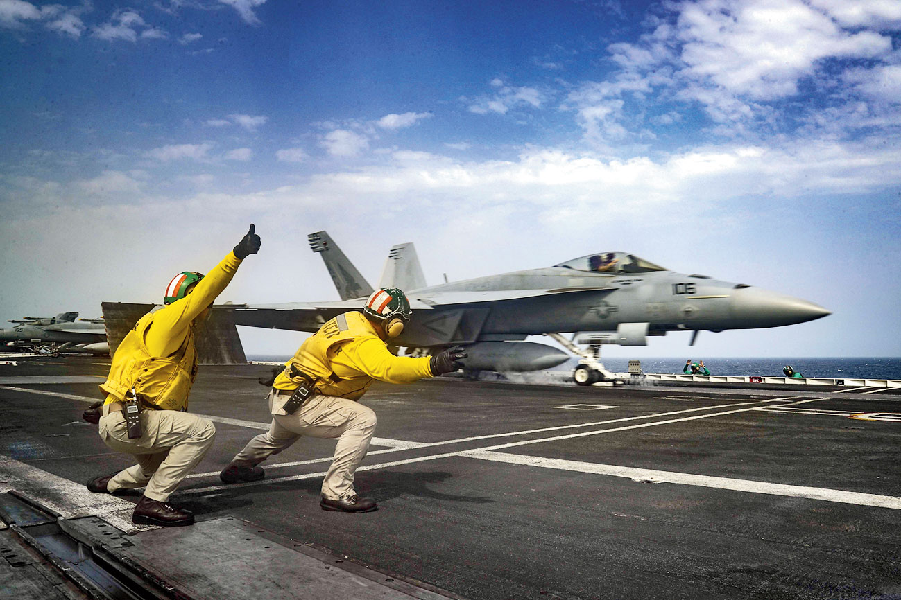  An F-18 Super Hornet takes off from the deck of the USS Abraham Lincoln in the Arabian Sea. 